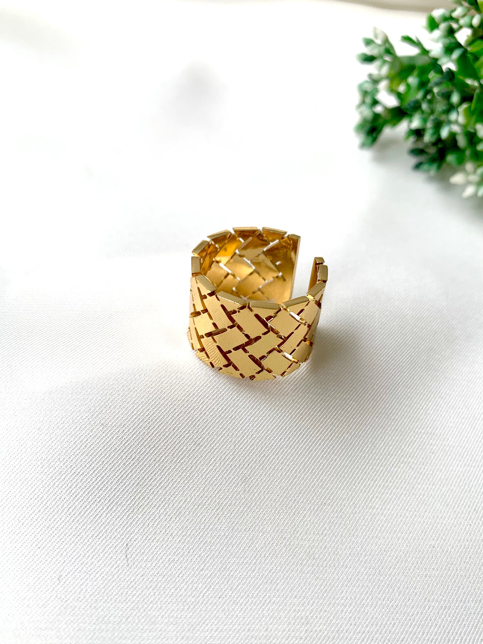Textured gold adjustable ring with woven grid pattern from Zamal Jewels’ Forma Collection