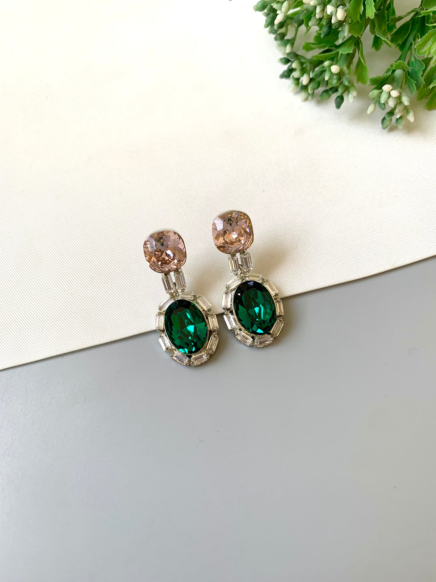 Handcrafted rhodium plated platinum finish earrings with baguette stones and Swarovski crystals in emerald tone