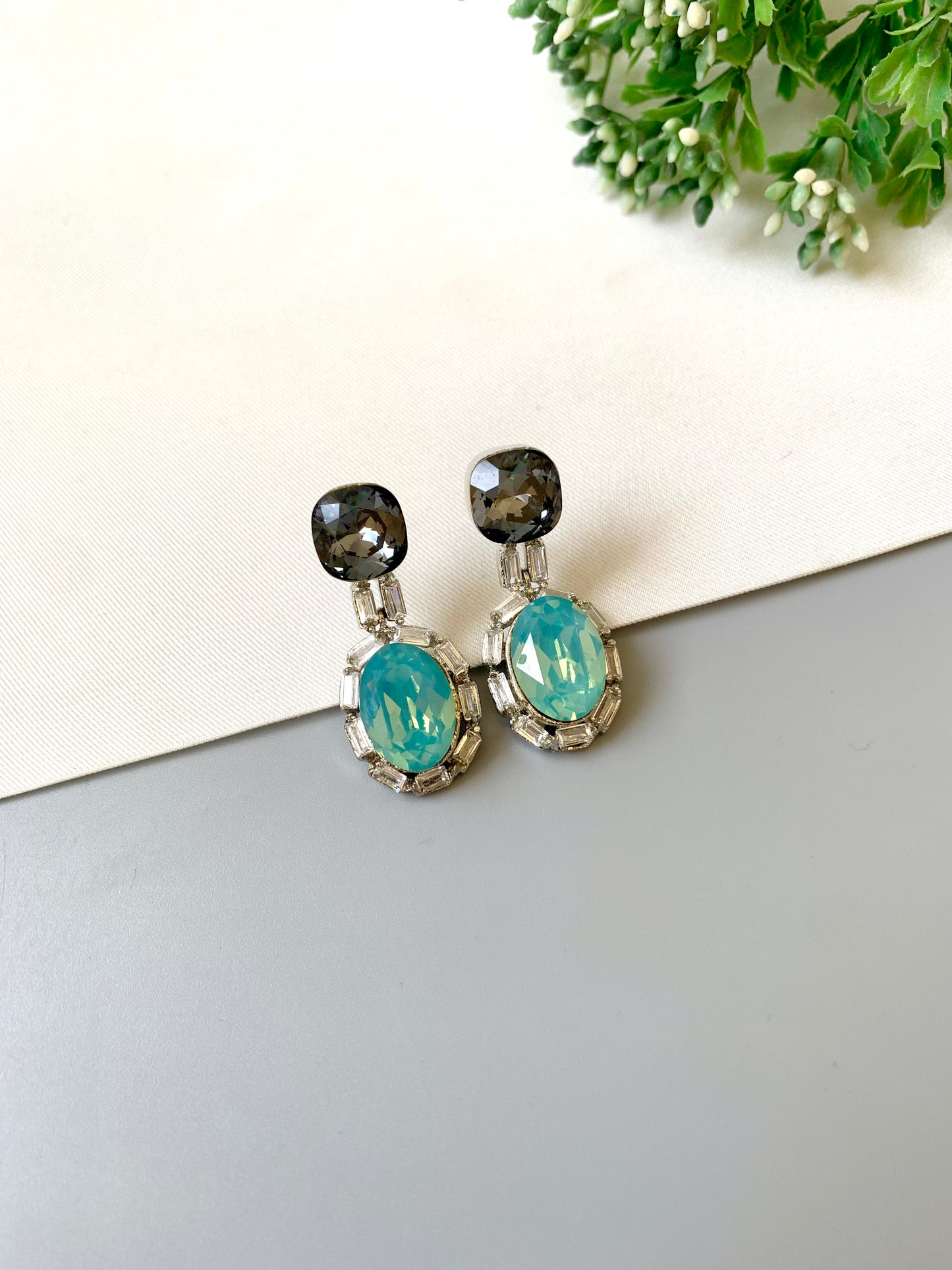 Handcrafted rhodium plated platinum finish earrings with baguette stones and Swarovski crystals in ferozi shade