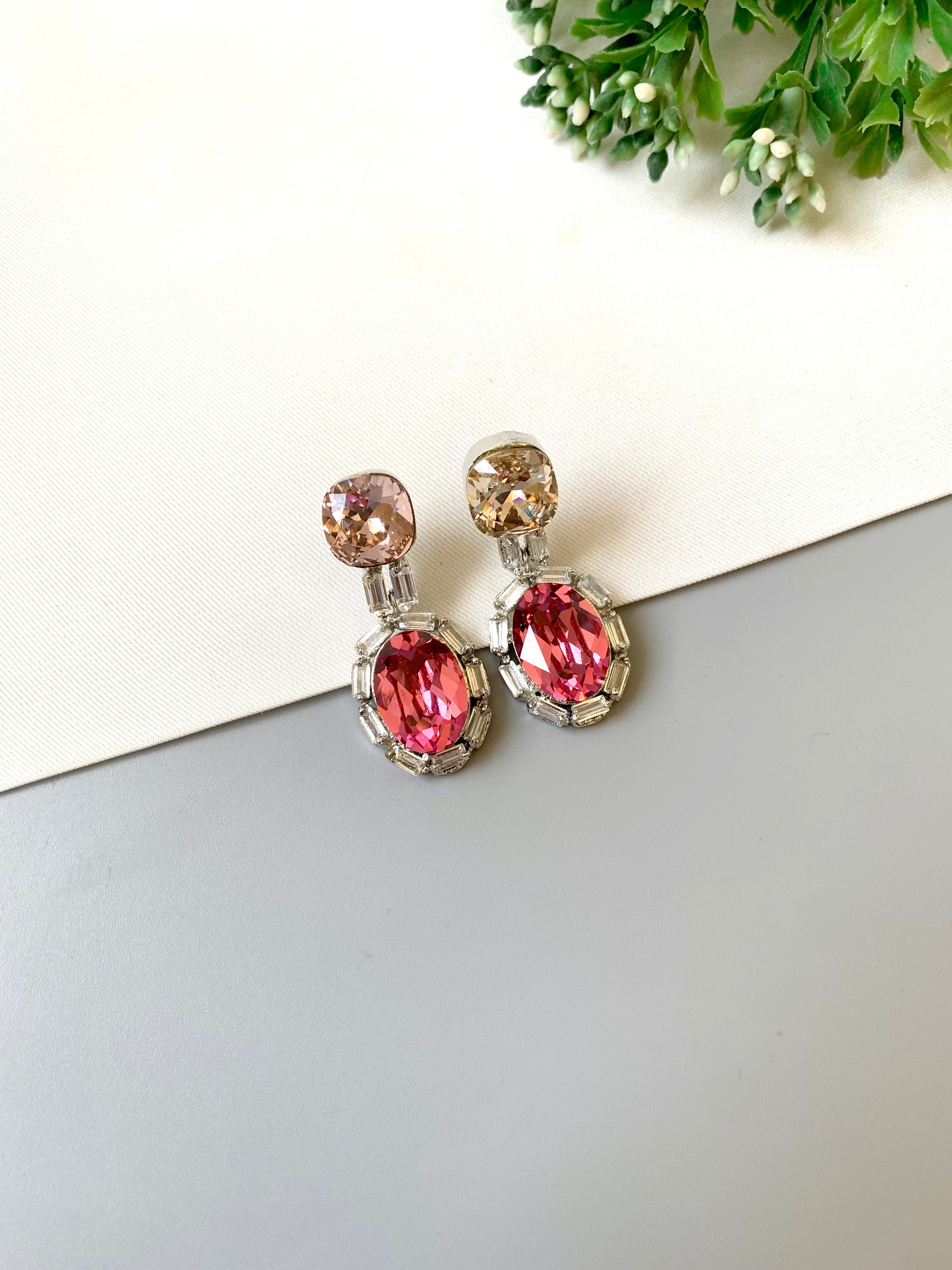 Handcrafted rhodium plated platinum finish earrings with baguette stones and Swarovski crystals in pink tone