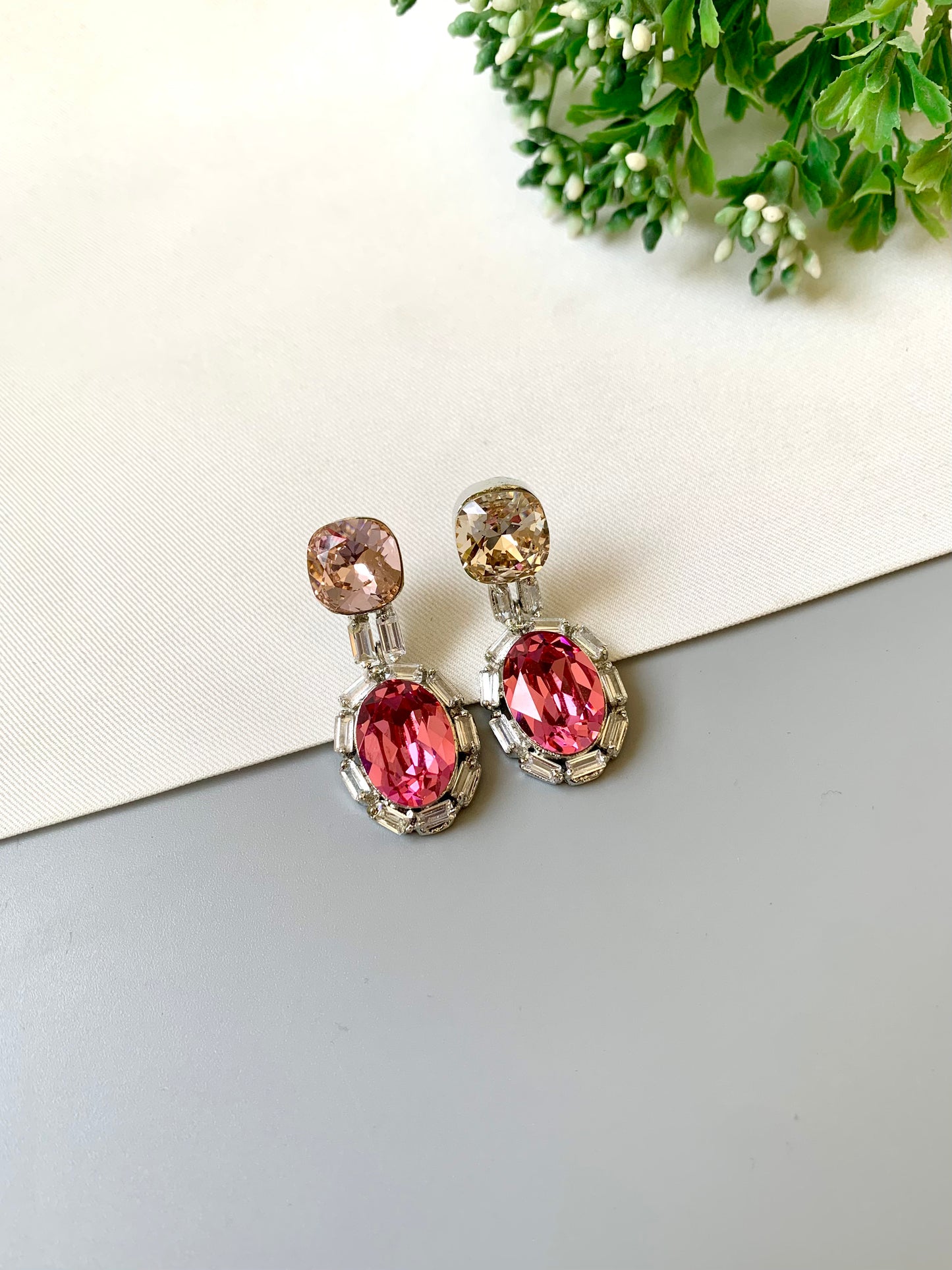 Handcrafted rhodium plated platinum finish earrings with baguette stones and Swarovski crystals in pink tone