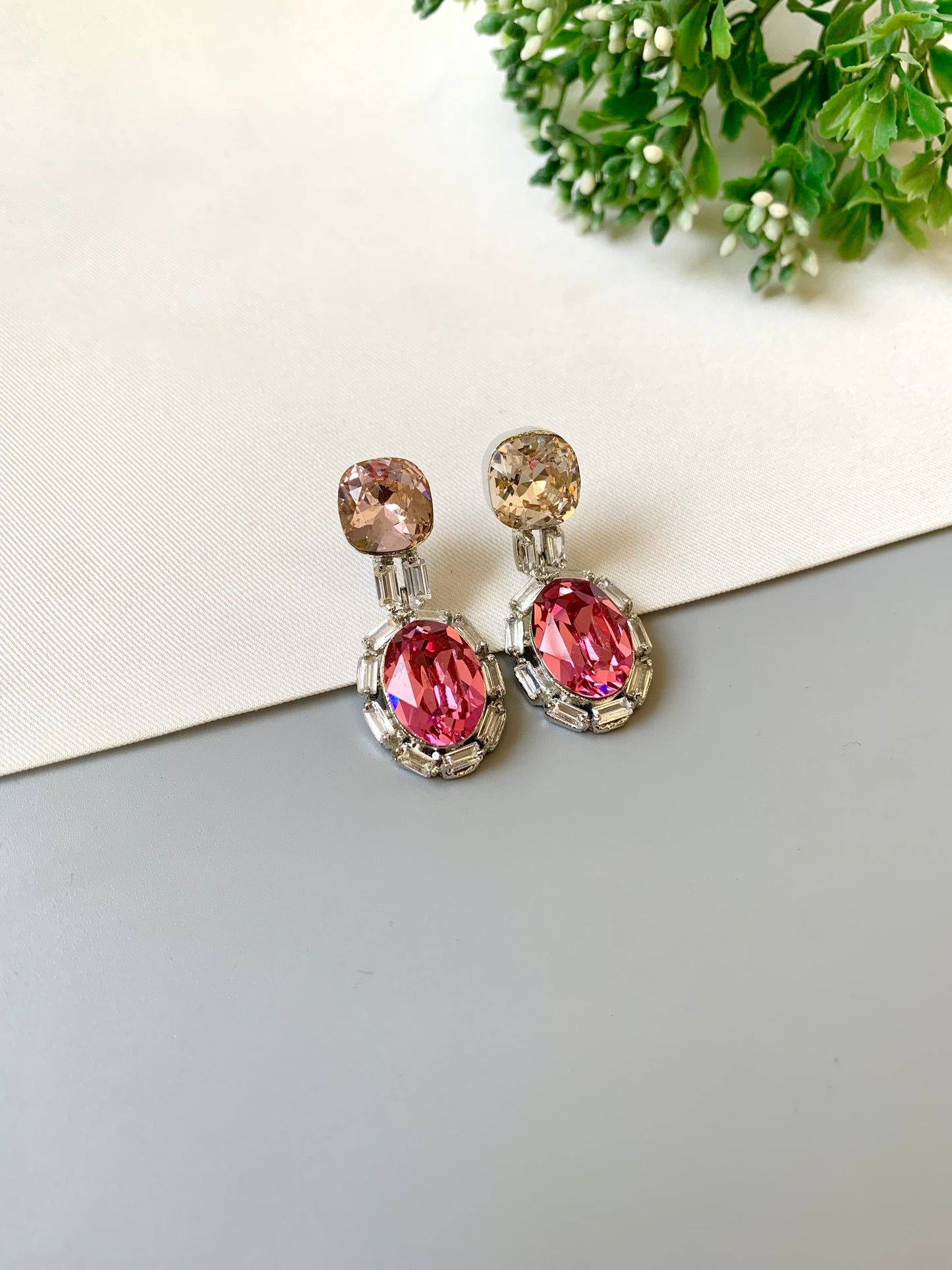 Handcrafted rhodium plated platinum finish earrings with baguette stones and Swarovski crystals in pink tone