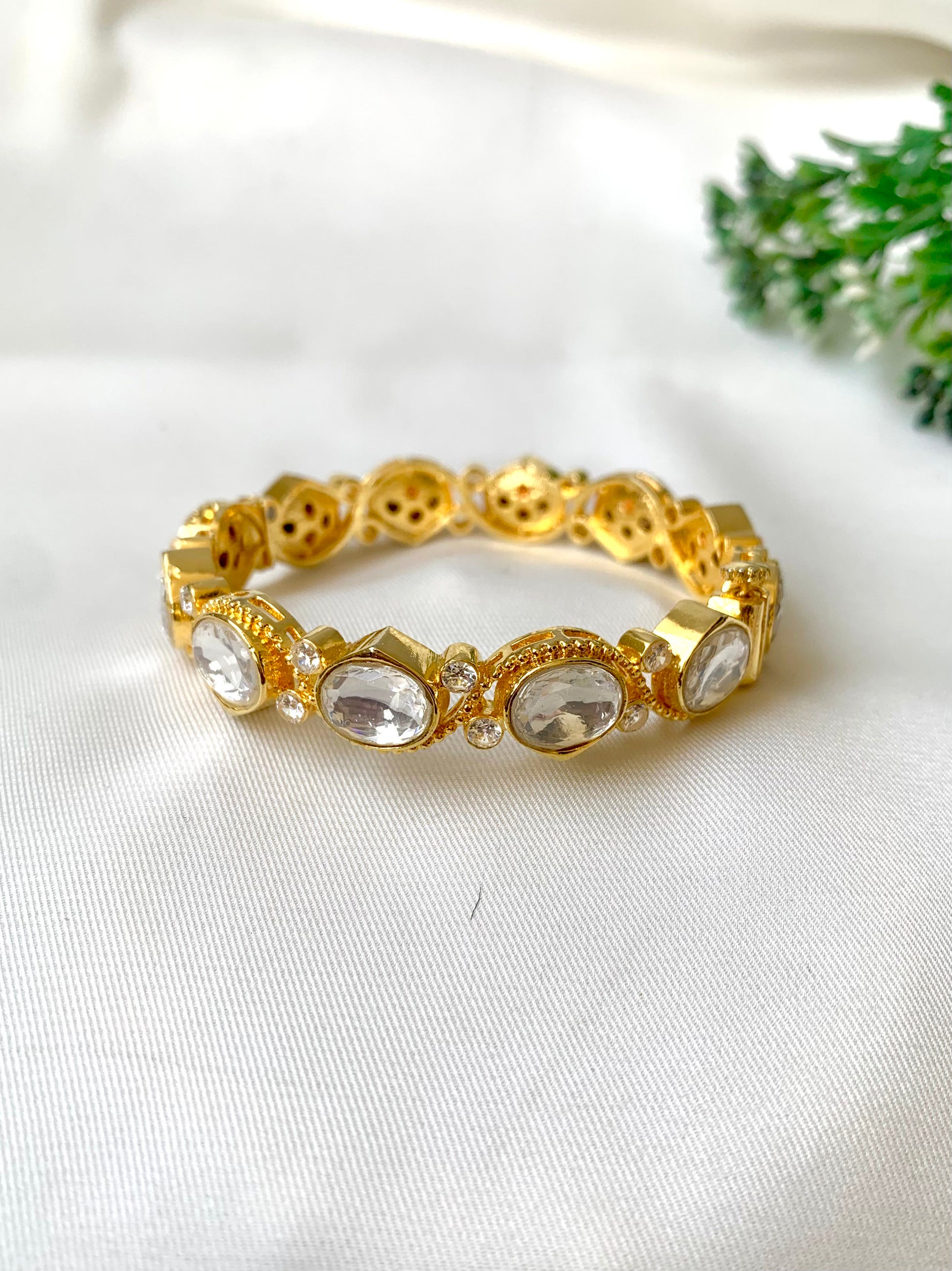 Handcrafted Arwah Bangle in 22kt gold plating with high-quality Moissanite Kundan stones and screw opening — by Zamal Jewels.