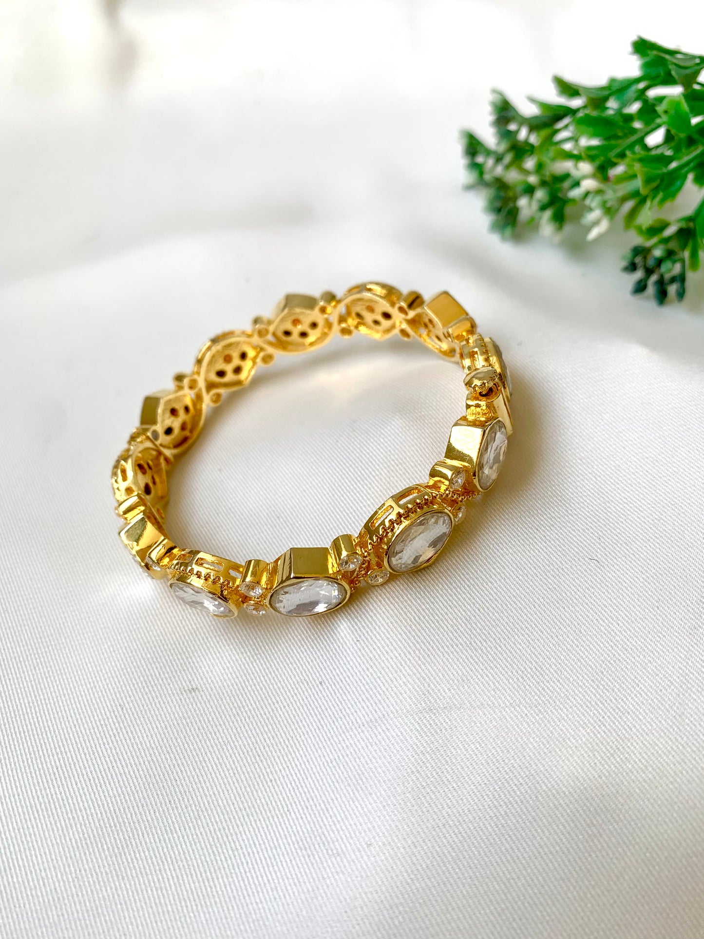 Handcrafted Arwah Bangle in 22kt gold plating with high-quality Moissanite Kundan stones and screw opening — by Zamal Jewels.