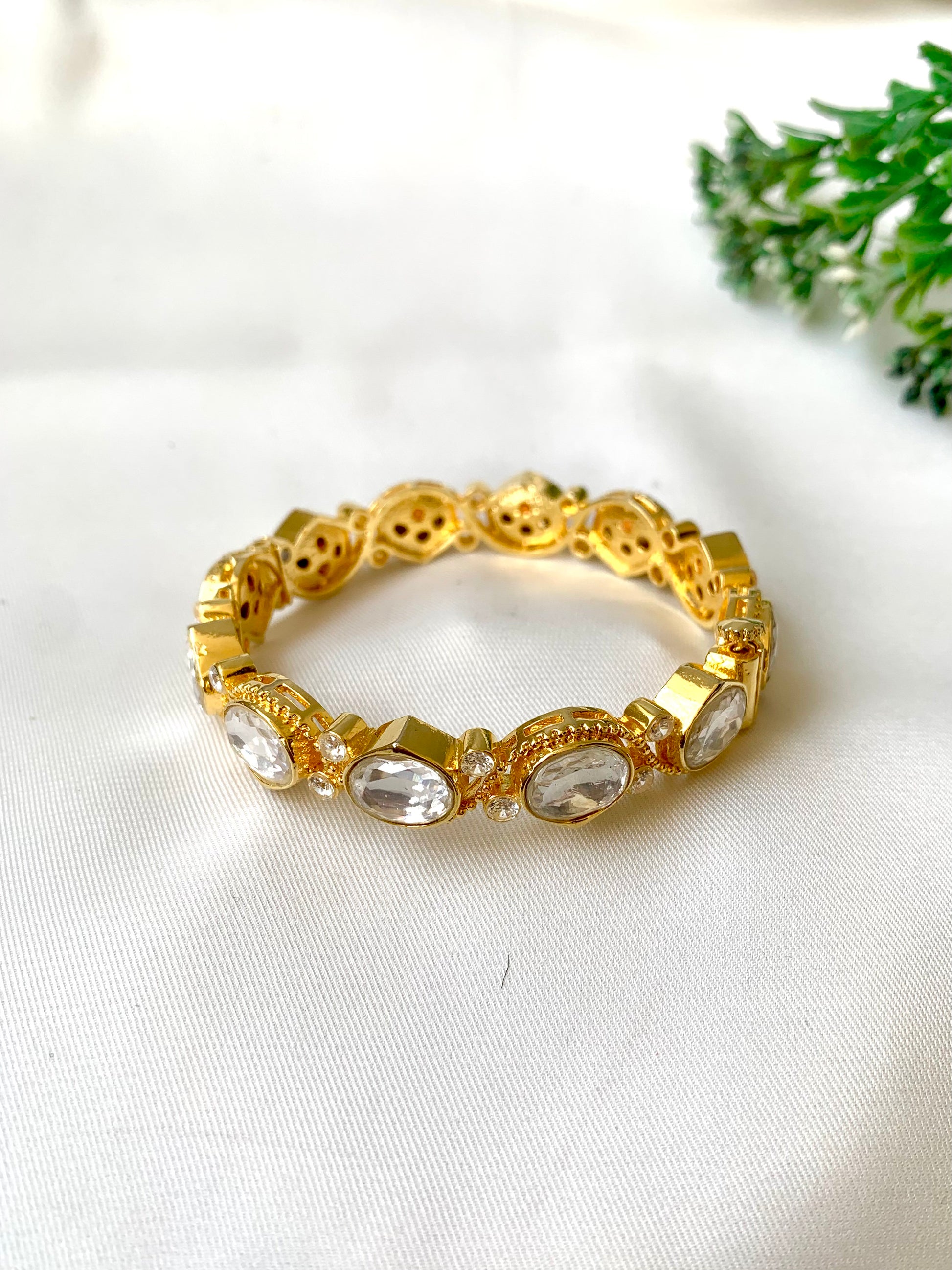 Handcrafted Arwah Bangle in 22kt gold plating with high-quality Moissanite Kundan stones and screw opening — by Zamal Jewels.