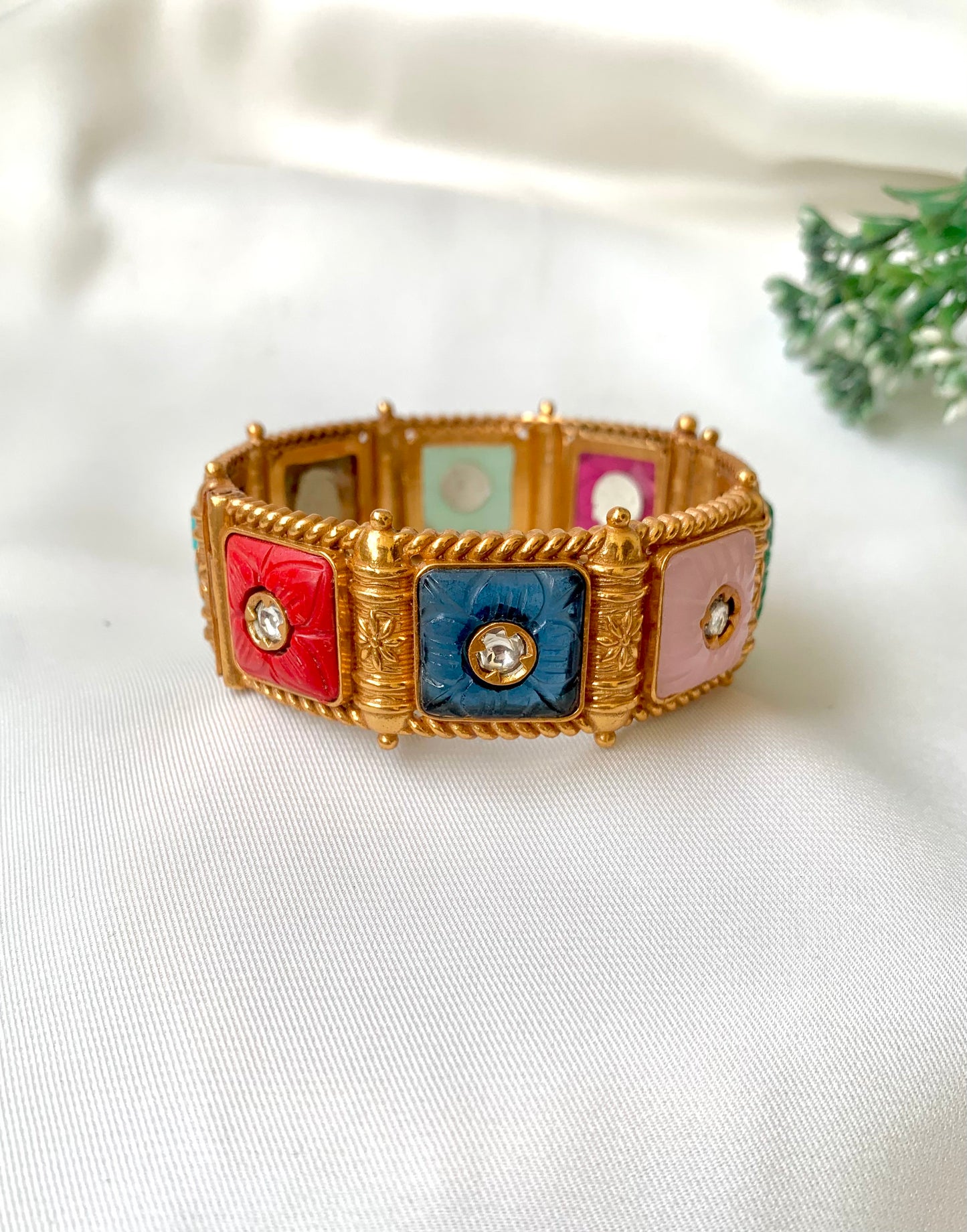 Handcrafted Arzella Bangle in 22kt gold plating with Polki Kundan and hand-carved Sapphire, Ruby, Emerald & Onyx stones — by Zamal Jewels.