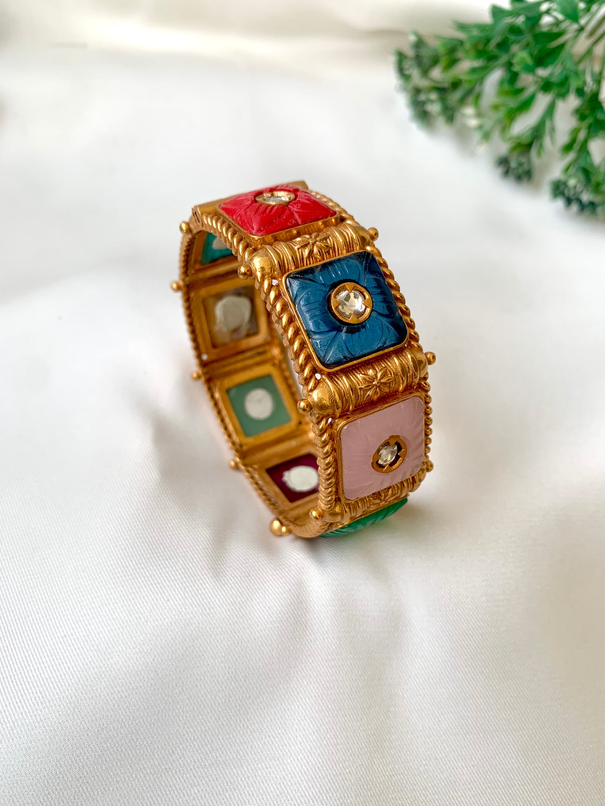 Handcrafted Arzella Bangle in 22kt gold plating with Polki Kundan and hand-carved Sapphire, Ruby, Emerald & Onyx stones — by Zamal Jewels.