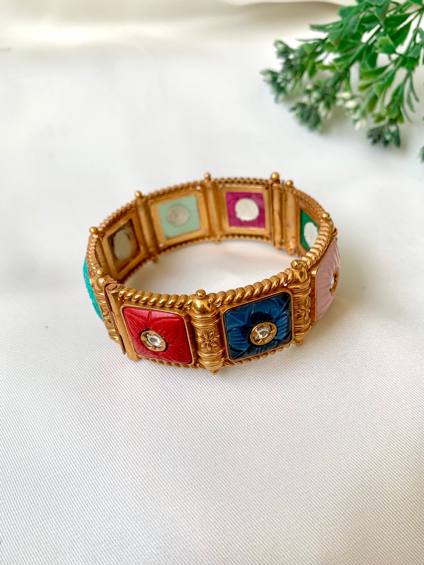 Handcrafted Arzella Bangle in 22kt gold plating with Polki Kundan and hand-carved Sapphire, Ruby, Emerald & Onyx stones — by Zamal Jewels.