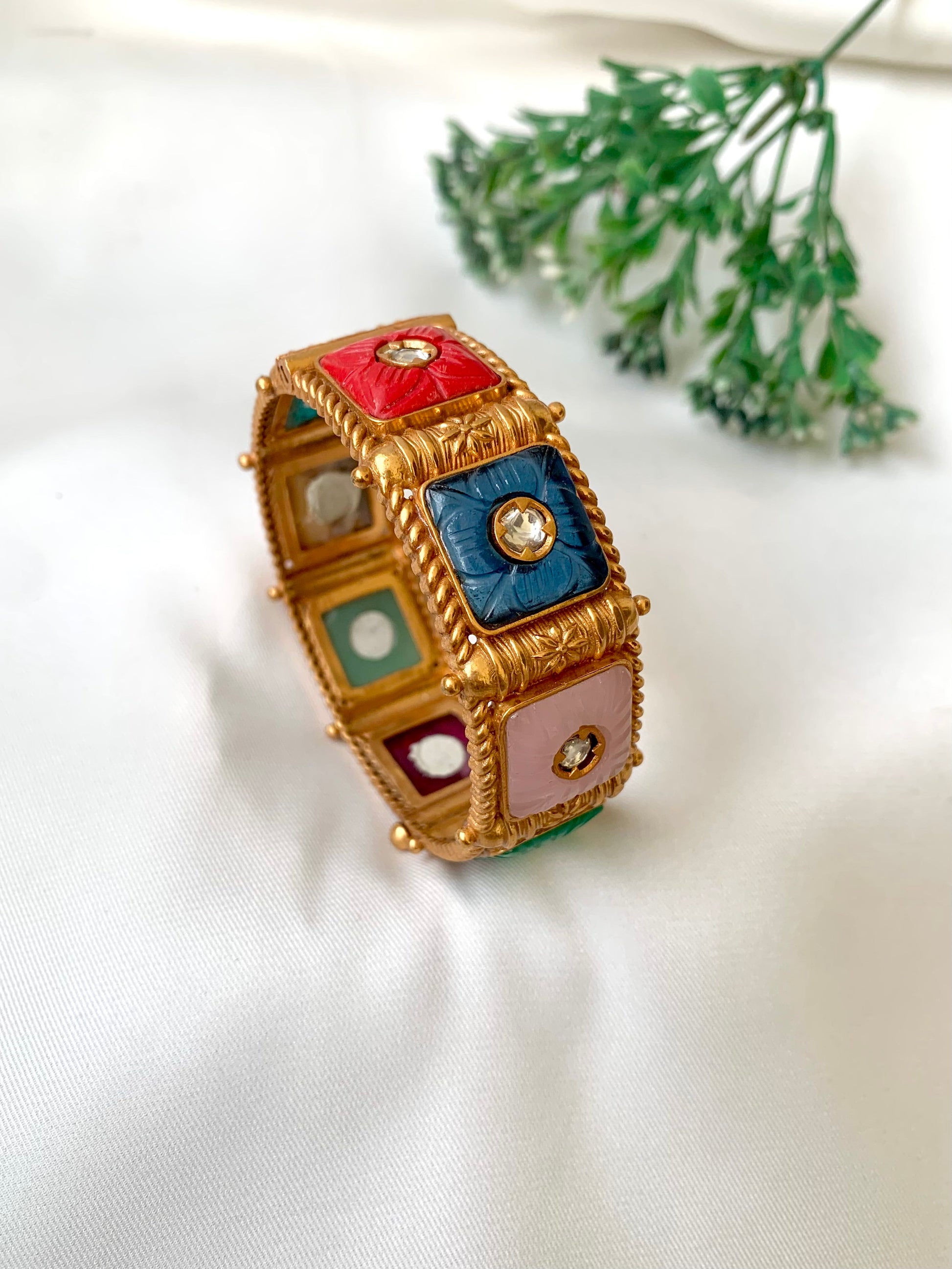 Handcrafted Arzella Bangle in 22kt gold plating with Polki Kundan and hand-carved Sapphire, Ruby, Emerald & Onyx stones — by Zamal Jewels.