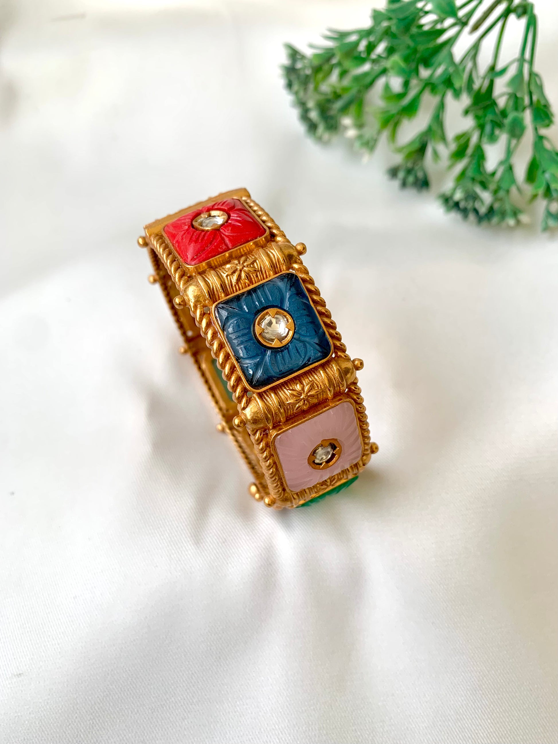Handcrafted Arzella Bangle in 22kt gold plating with Polki Kundan and hand-carved Sapphire, Ruby, Emerald & Onyx stones — by Zamal Jewels.