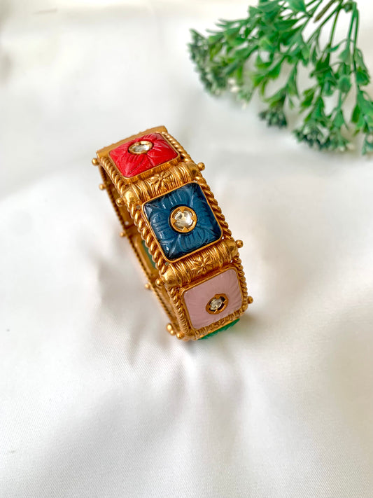 Handcrafted Arzella Bangle in 22kt gold plating with Polki Kundan and hand-carved Sapphire, Ruby, Emerald & Onyx stones — by Zamal Jewels.