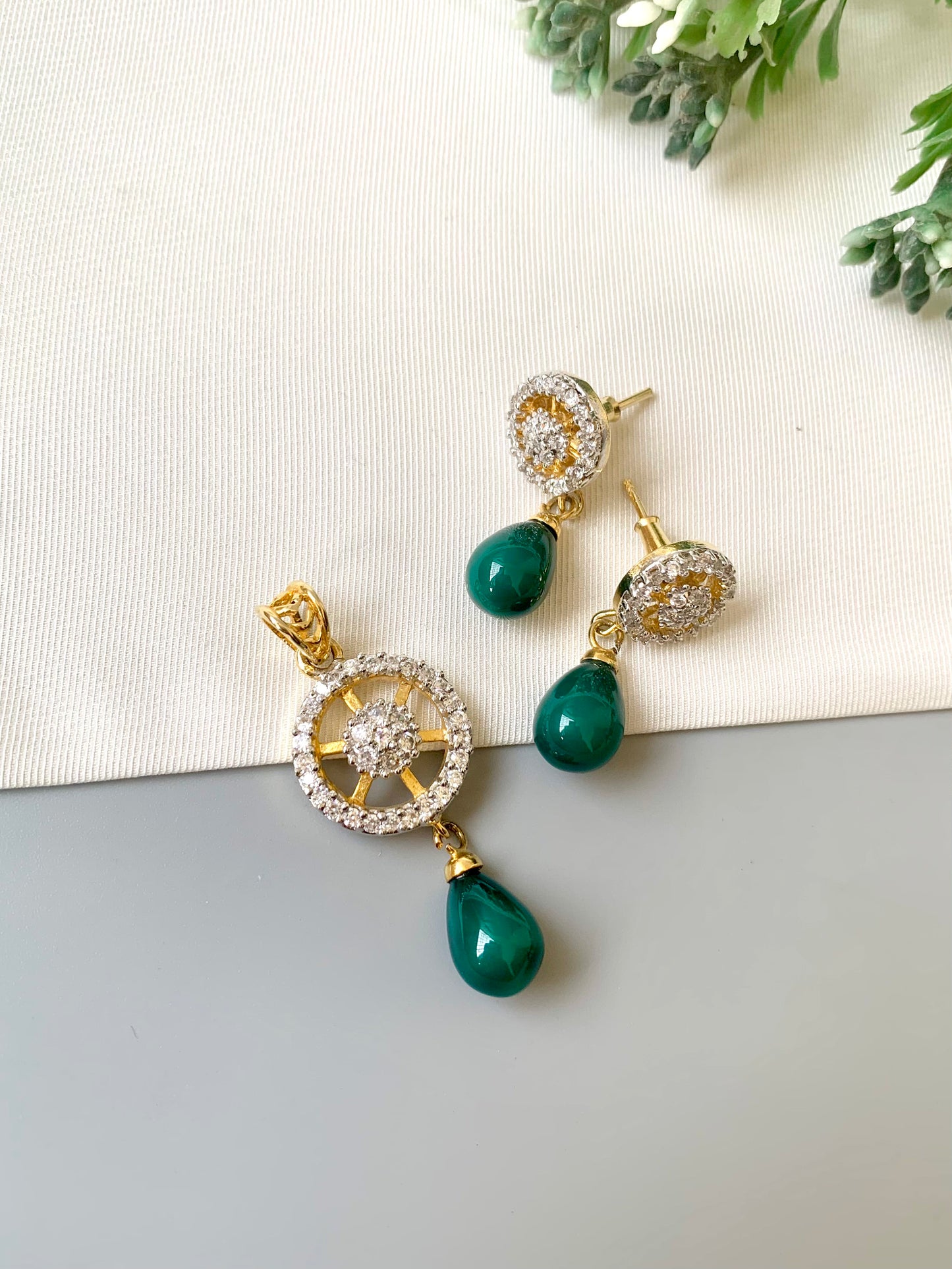 Handcrafted Aveline Pendant Set in 22kt gold plating with high-quality American Diamonds and Semi-Precious Emerald teardrop stones by Zamal Jewels.