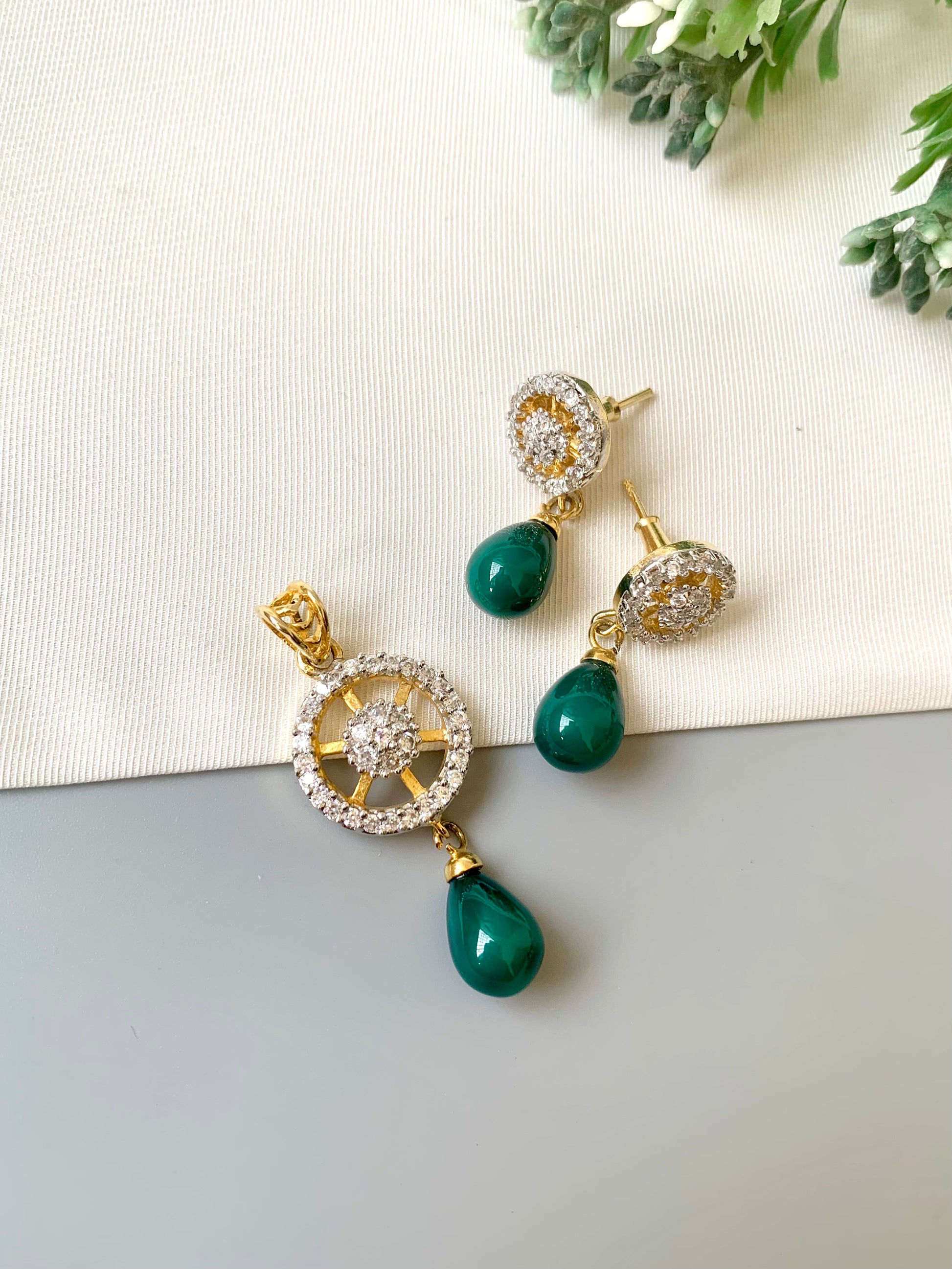 Handcrafted Aveline Pendant Set in 22kt gold plating with high-quality American Diamonds and Semi-Precious Emerald teardrop stones by Zamal Jewels.
