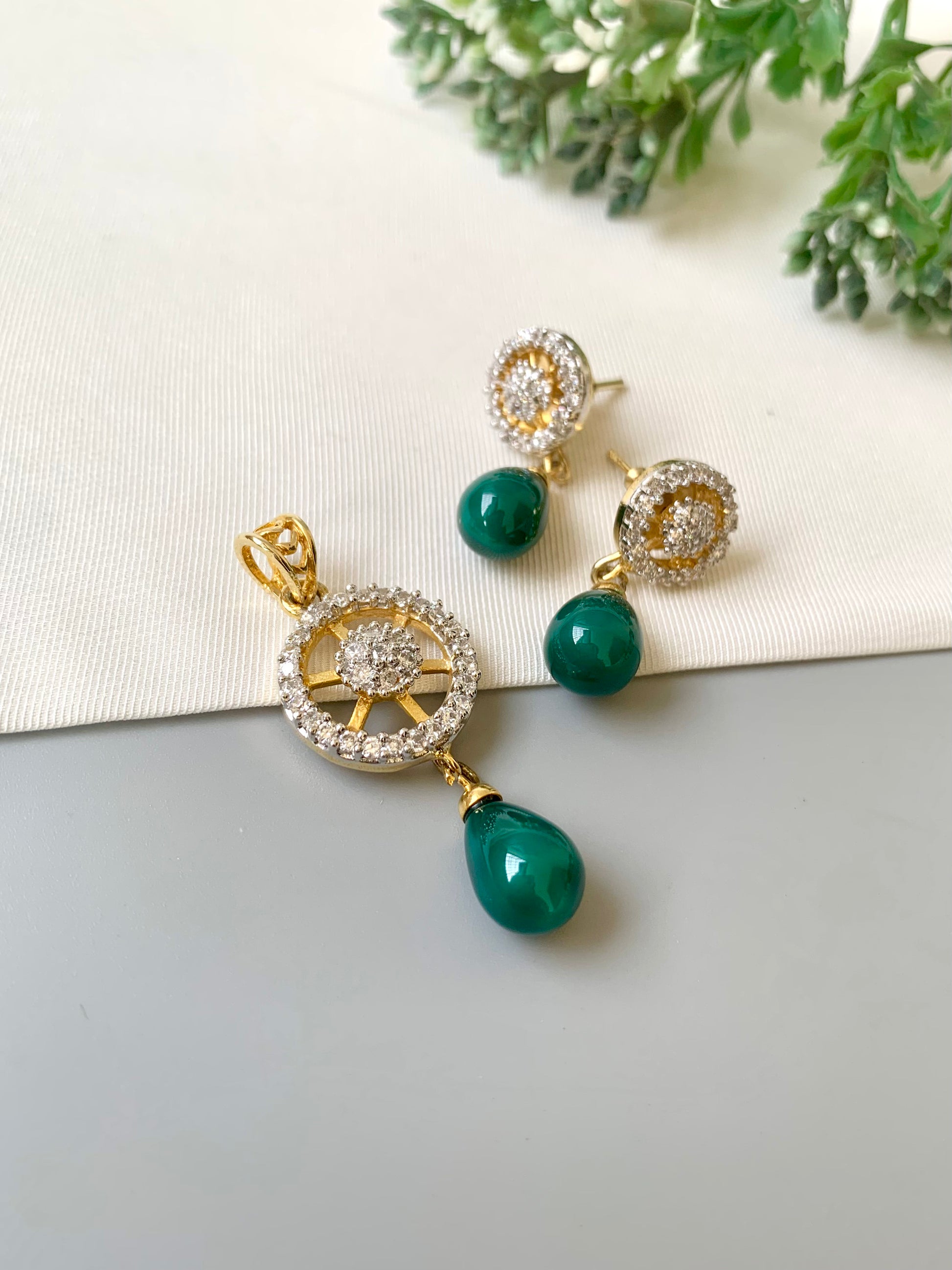 Handcrafted Aveline Pendant Set in 22kt gold plating with high-quality American Diamonds and Semi-Precious Emerald teardrop stones by Zamal Jewels.