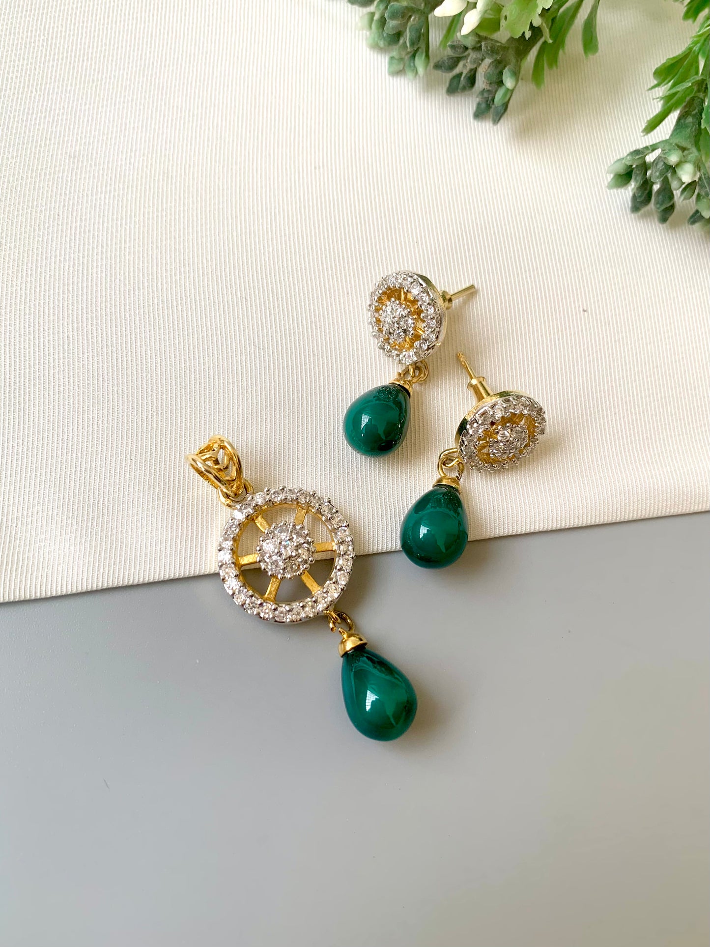 Handcrafted Aveline Pendant Set in 22kt gold plating with high-quality American Diamonds and Semi-Precious Emerald teardrop stones by Zamal Jewels.