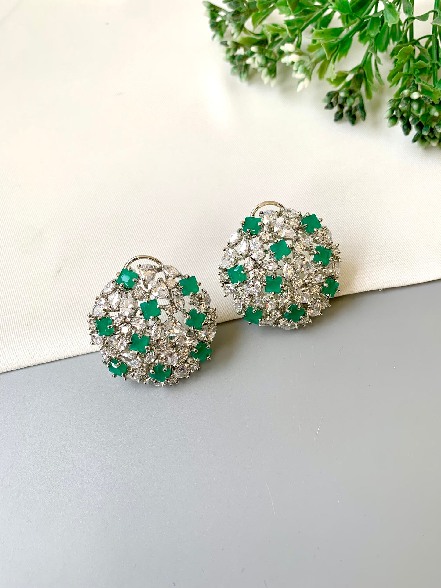 Handcrafted Celesta Studs in Emerald with American Diamonds and rhodium platinum polish — by Zamal Jewels.