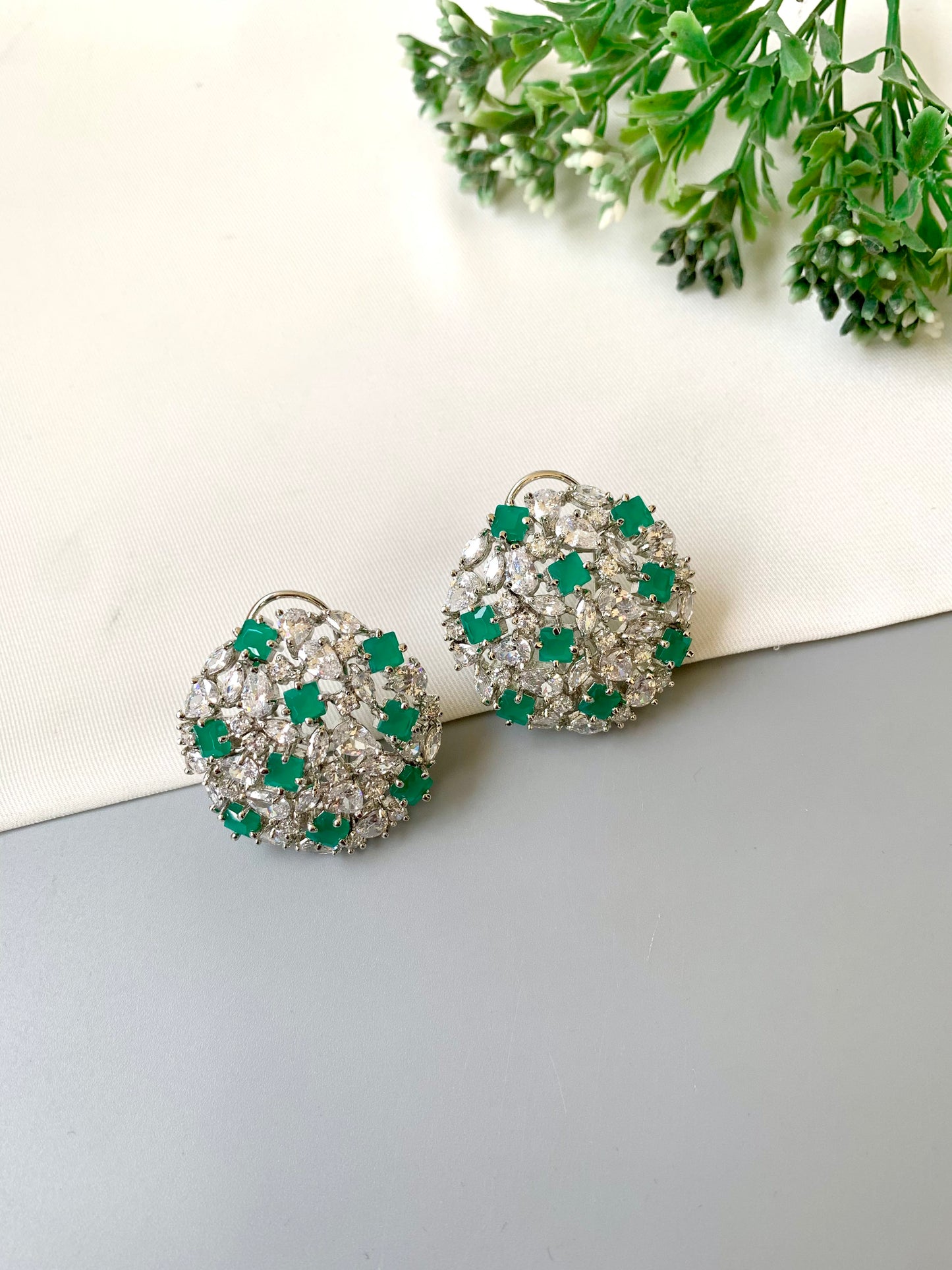 Handcrafted Celesta Studs in Emerald with American Diamonds and rhodium platinum polish — by Zamal Jewels.