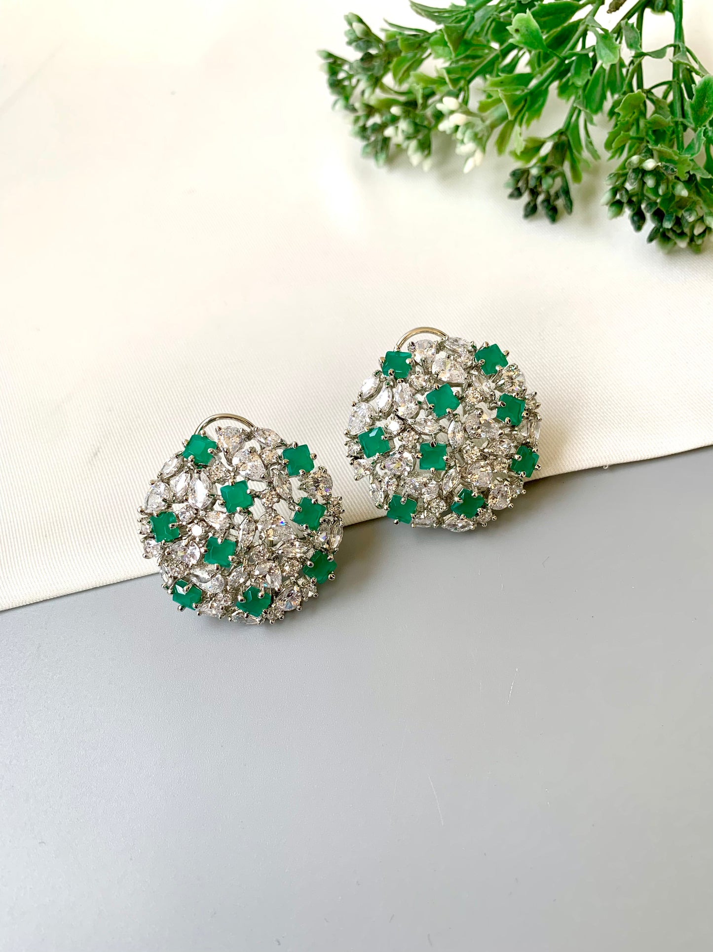 Handcrafted Celesta Studs in Emerald with American Diamonds and rhodium platinum polish — by Zamal Jewels.