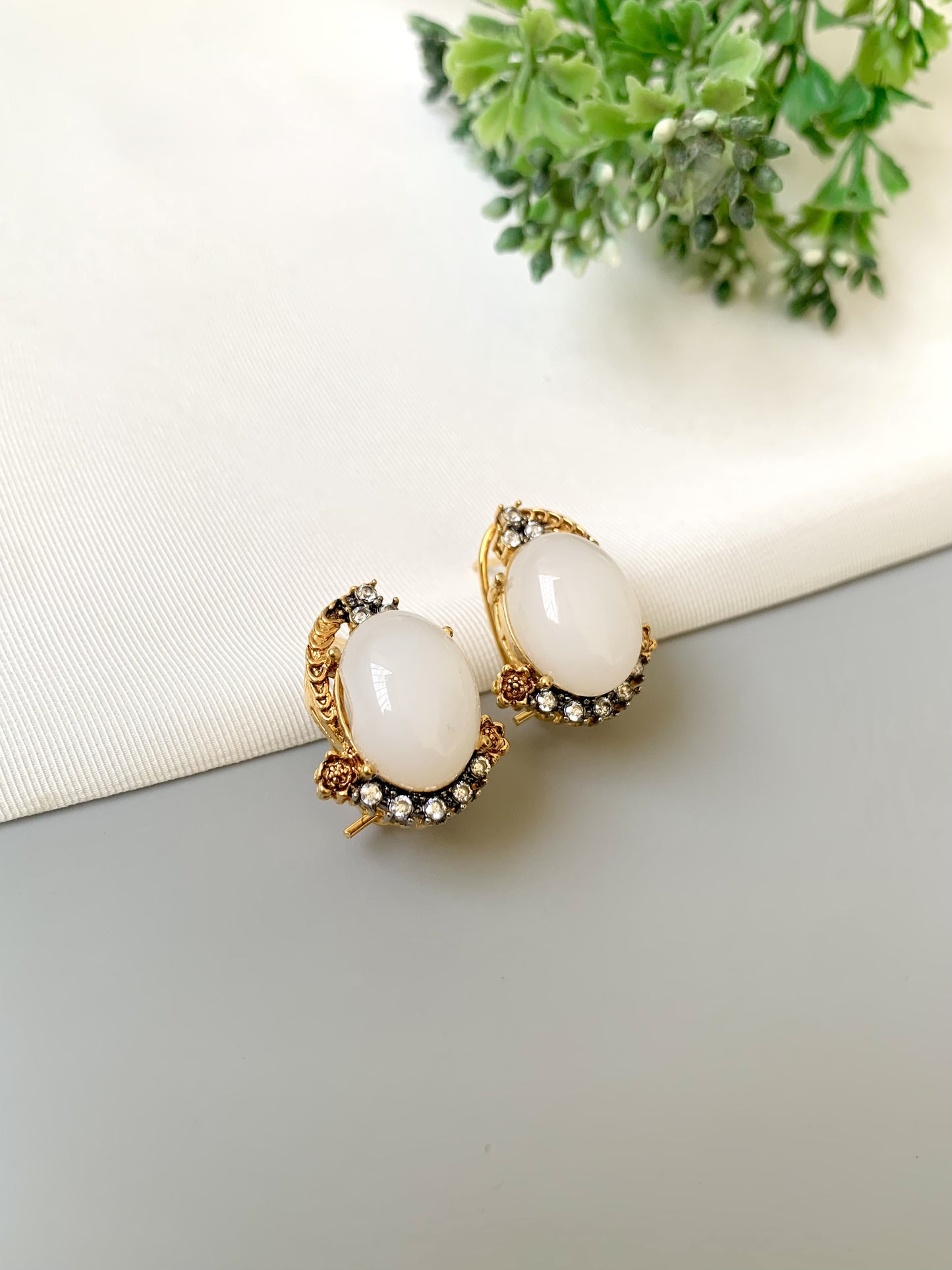 Handcrafted Elara White Zircon Studs in gold plating with oval zircon stones by Zamal Jewels.