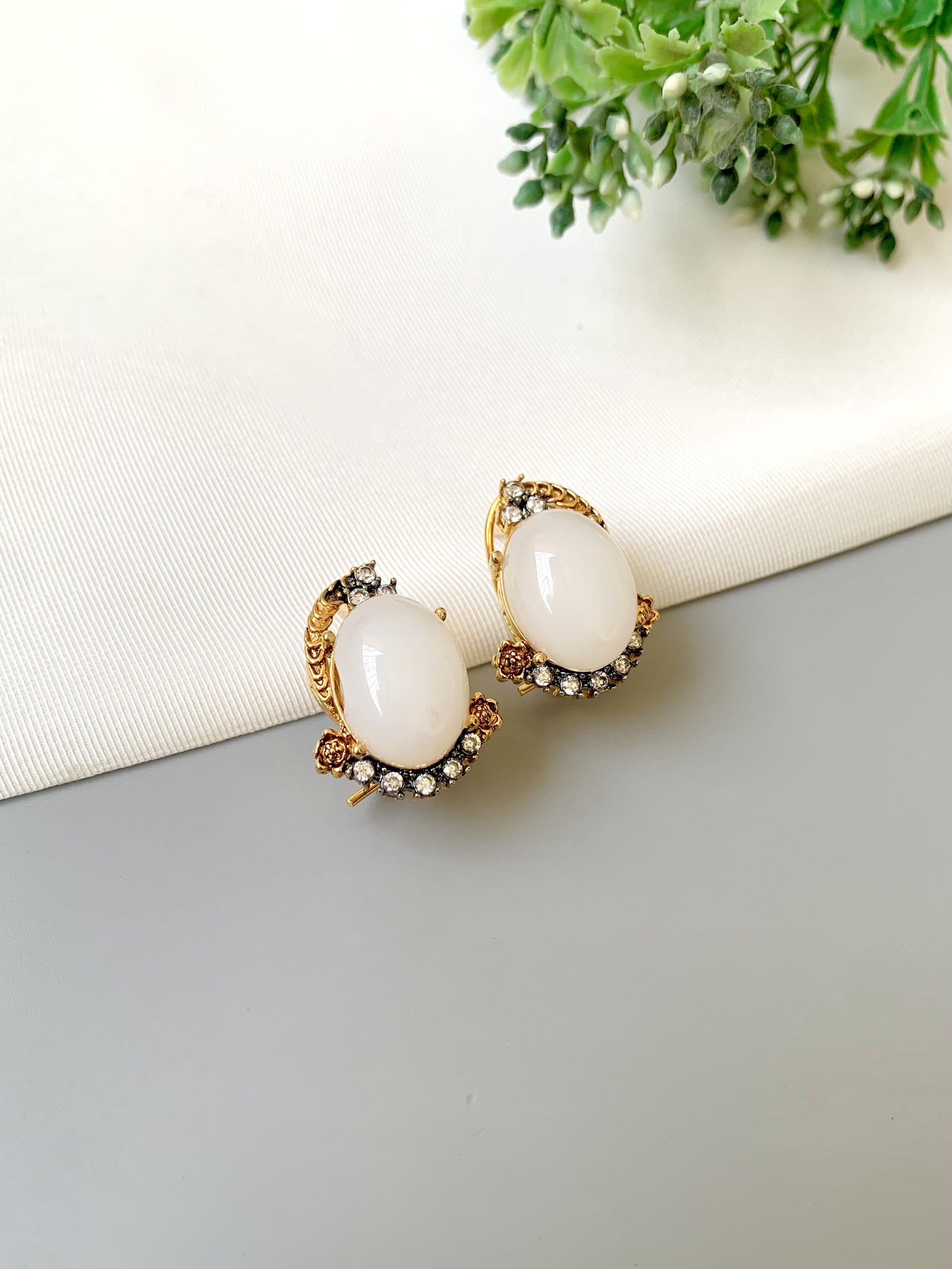Handcrafted Elara White Zircon Studs in gold plating with oval zircon stones by Zamal Jewels.