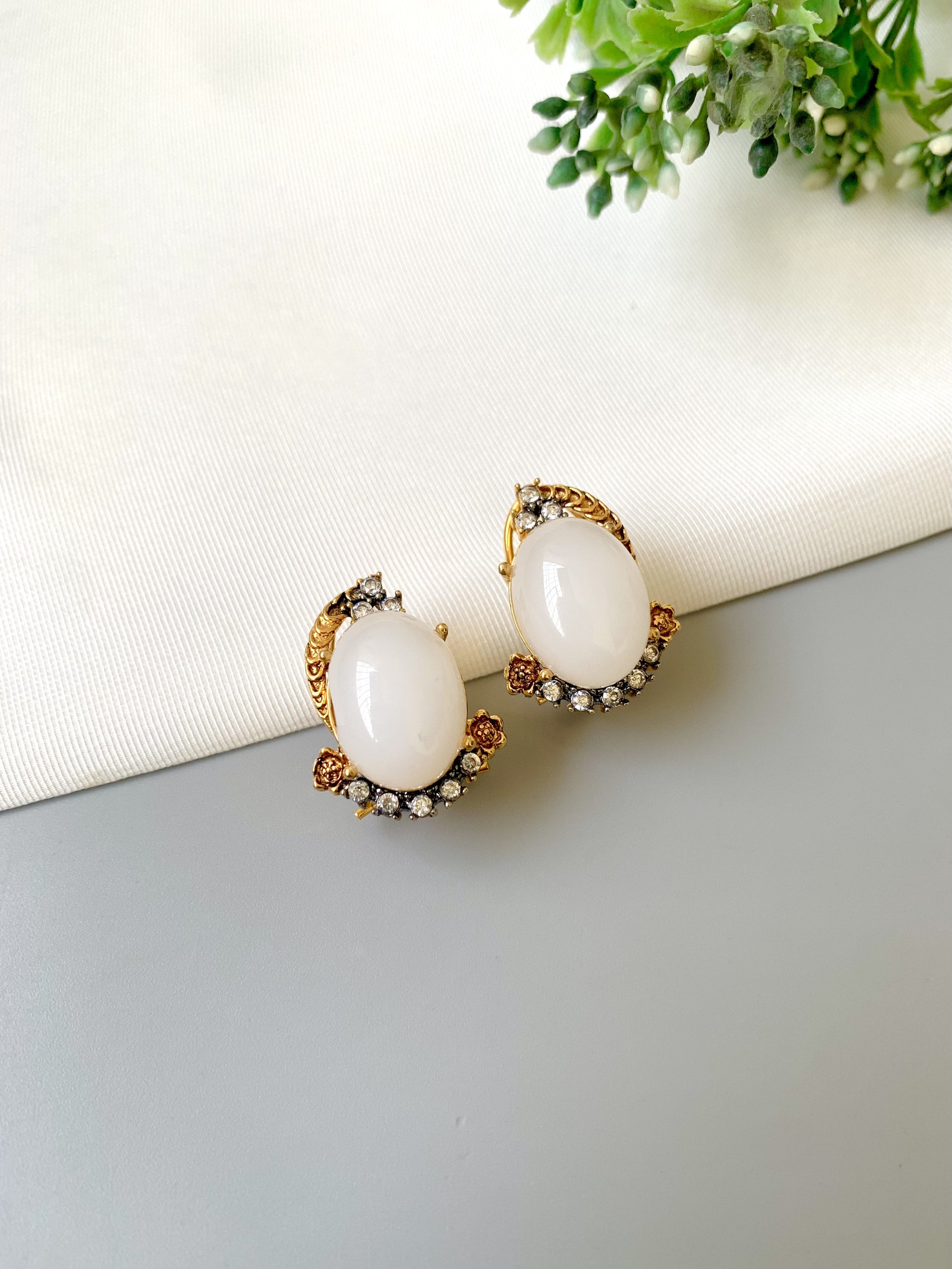 Handcrafted Elara White Zircon Studs in gold plating with oval zircon stones by Zamal Jewels.