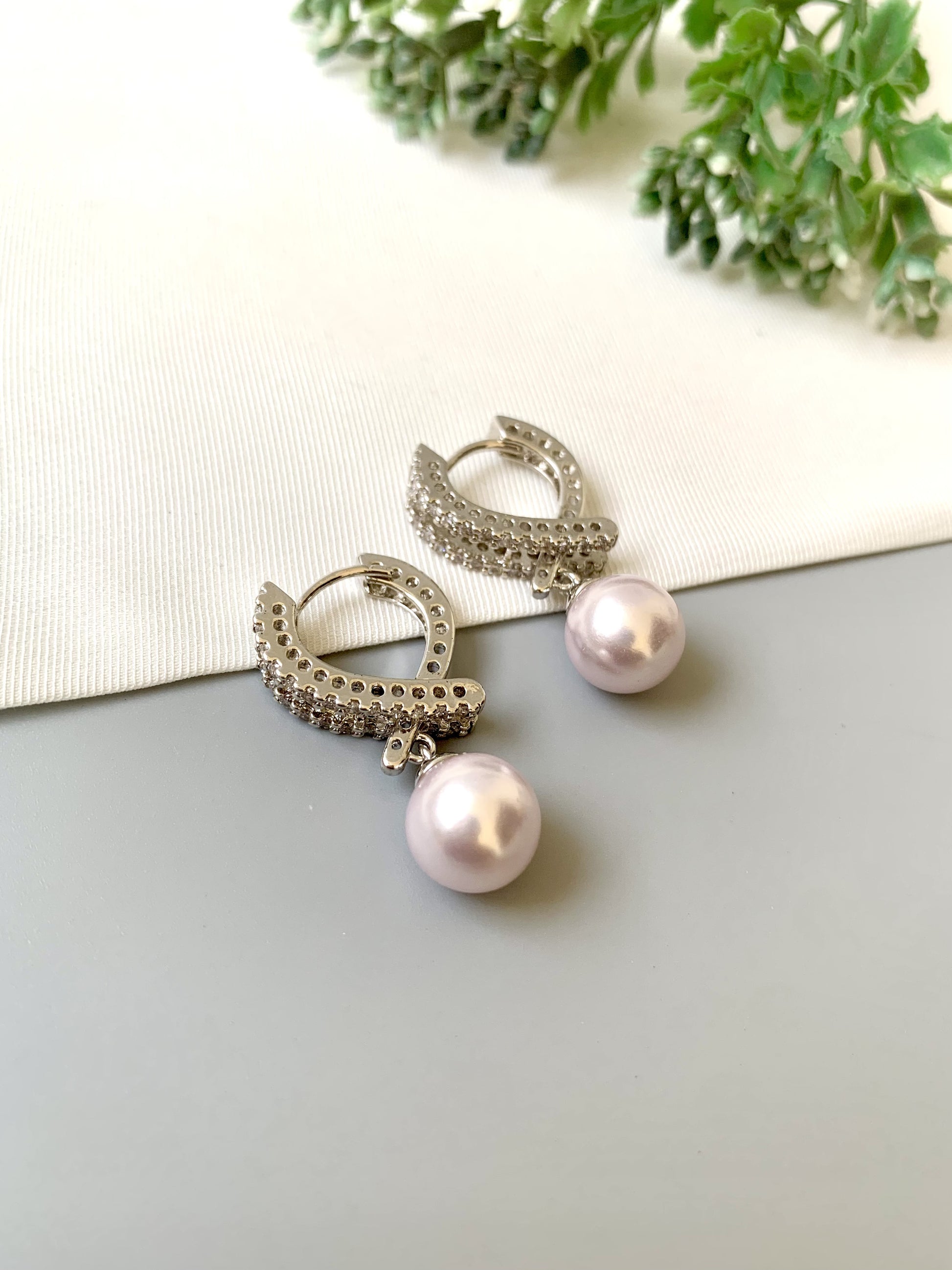 Handcrafted Elora Earrings in rhodium plating with American Diamonds and Semi-Precious Pearls — by Zamal Jewels.