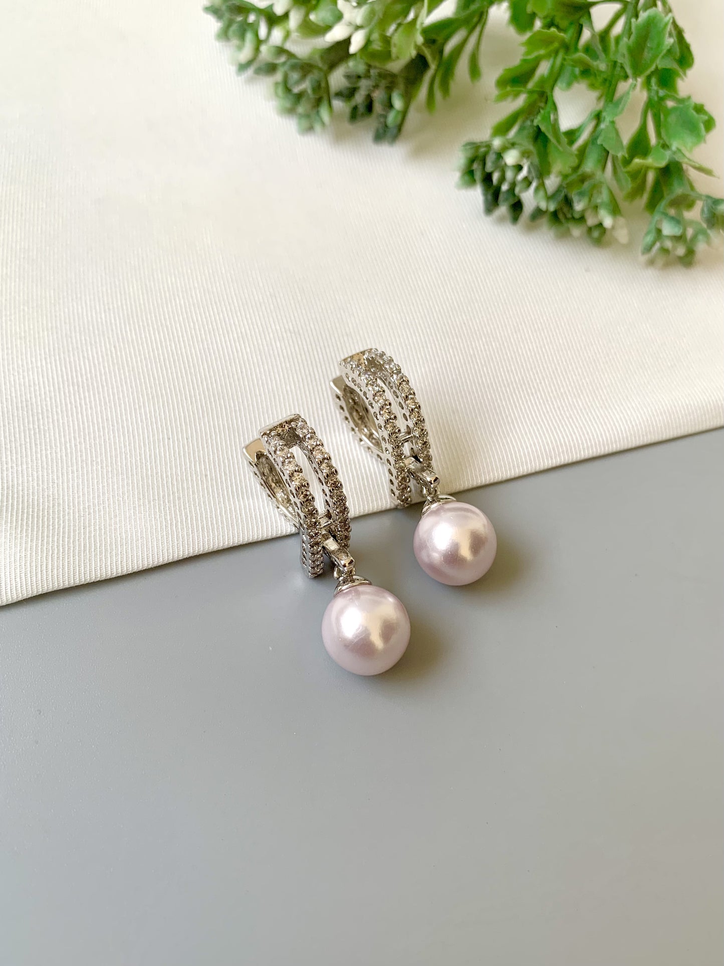 Handcrafted Elora Earrings in rhodium plating with American Diamonds and Semi-Precious Pearls — by Zamal Jewels.