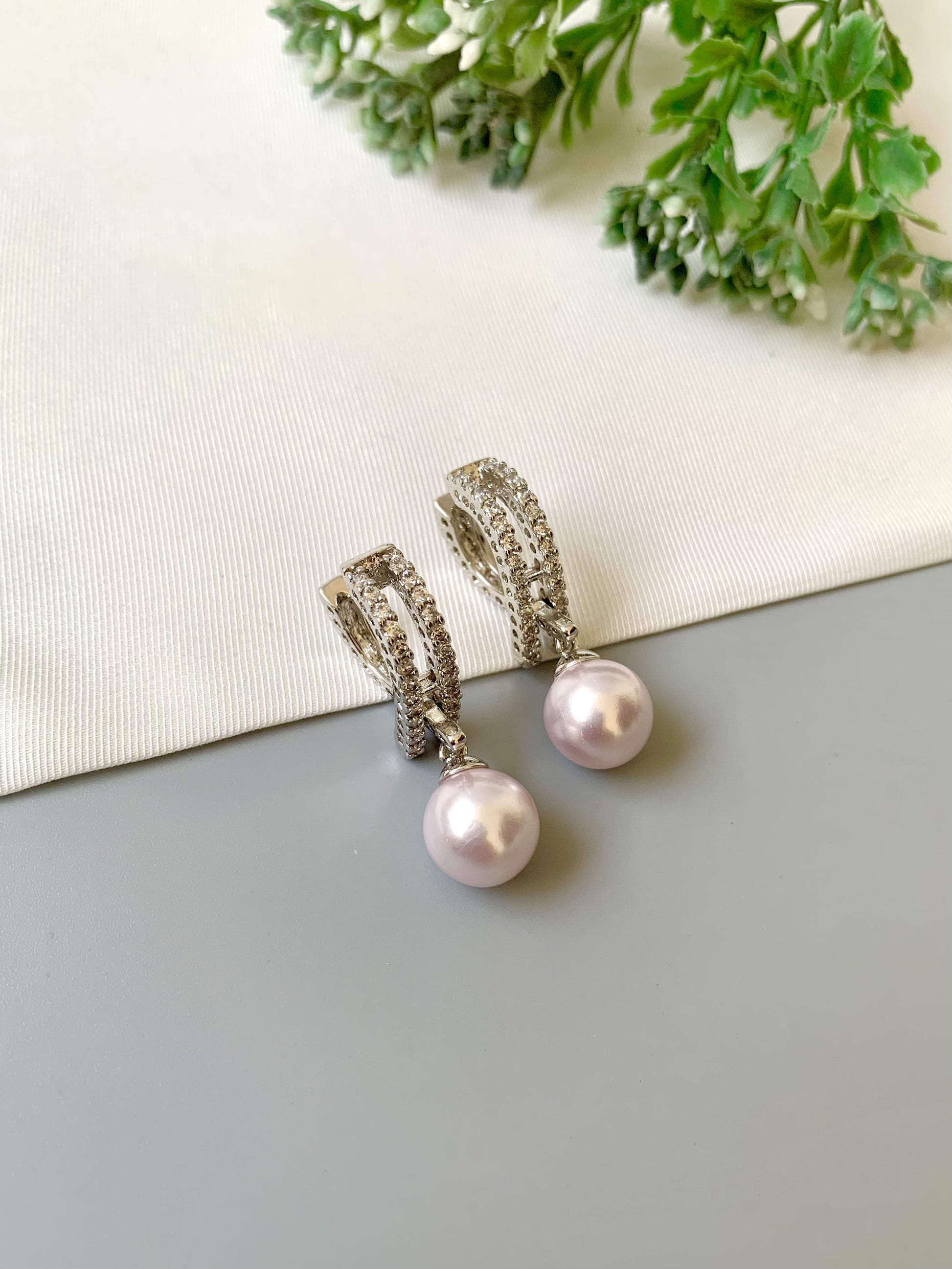 Handcrafted Elora Earrings in rhodium plating with American Diamonds and Semi-Precious Pearls — by Zamal Jewels.