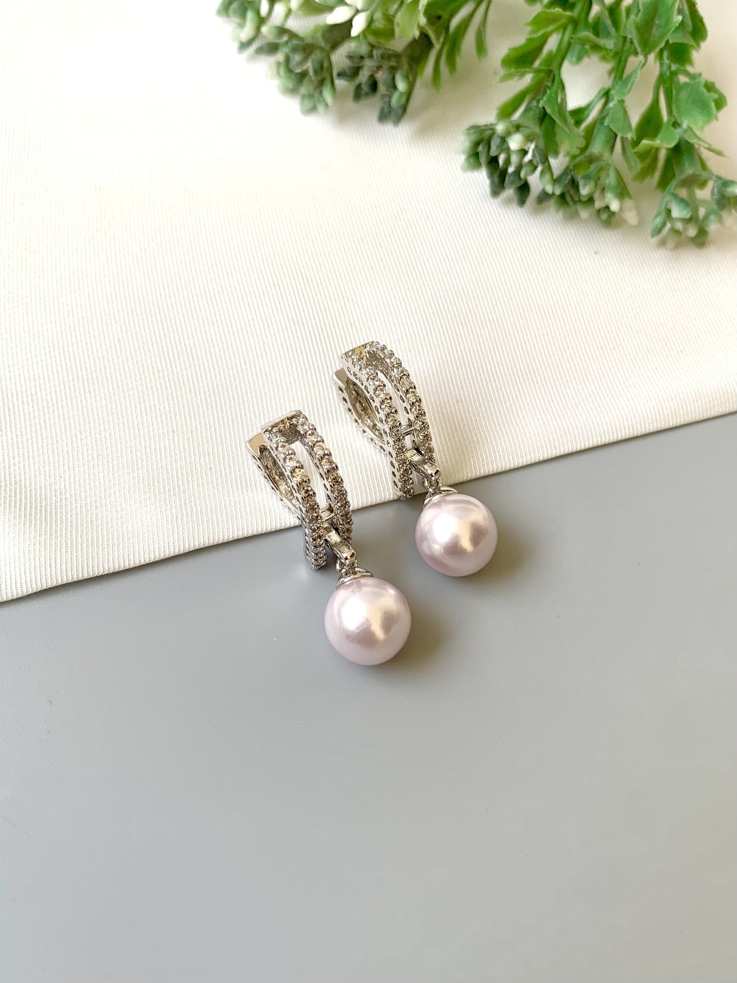 Handcrafted Elora Earrings in rhodium plating with American Diamonds and Semi-Precious Pearls — by Zamal Jewels.