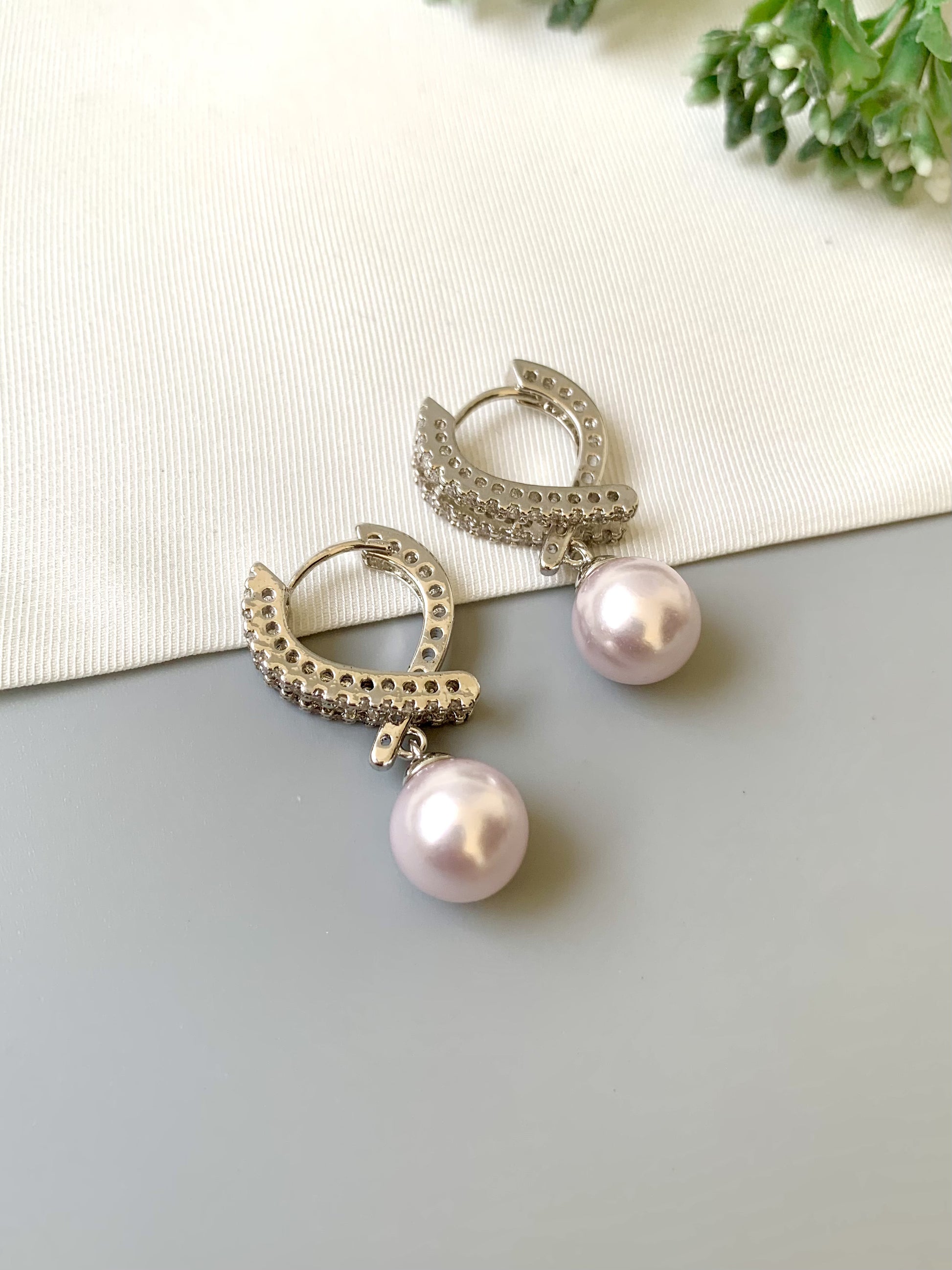 Handcrafted Elora Earrings in rhodium plating with American Diamonds and Semi-Precious Pearls — by Zamal Jewels.