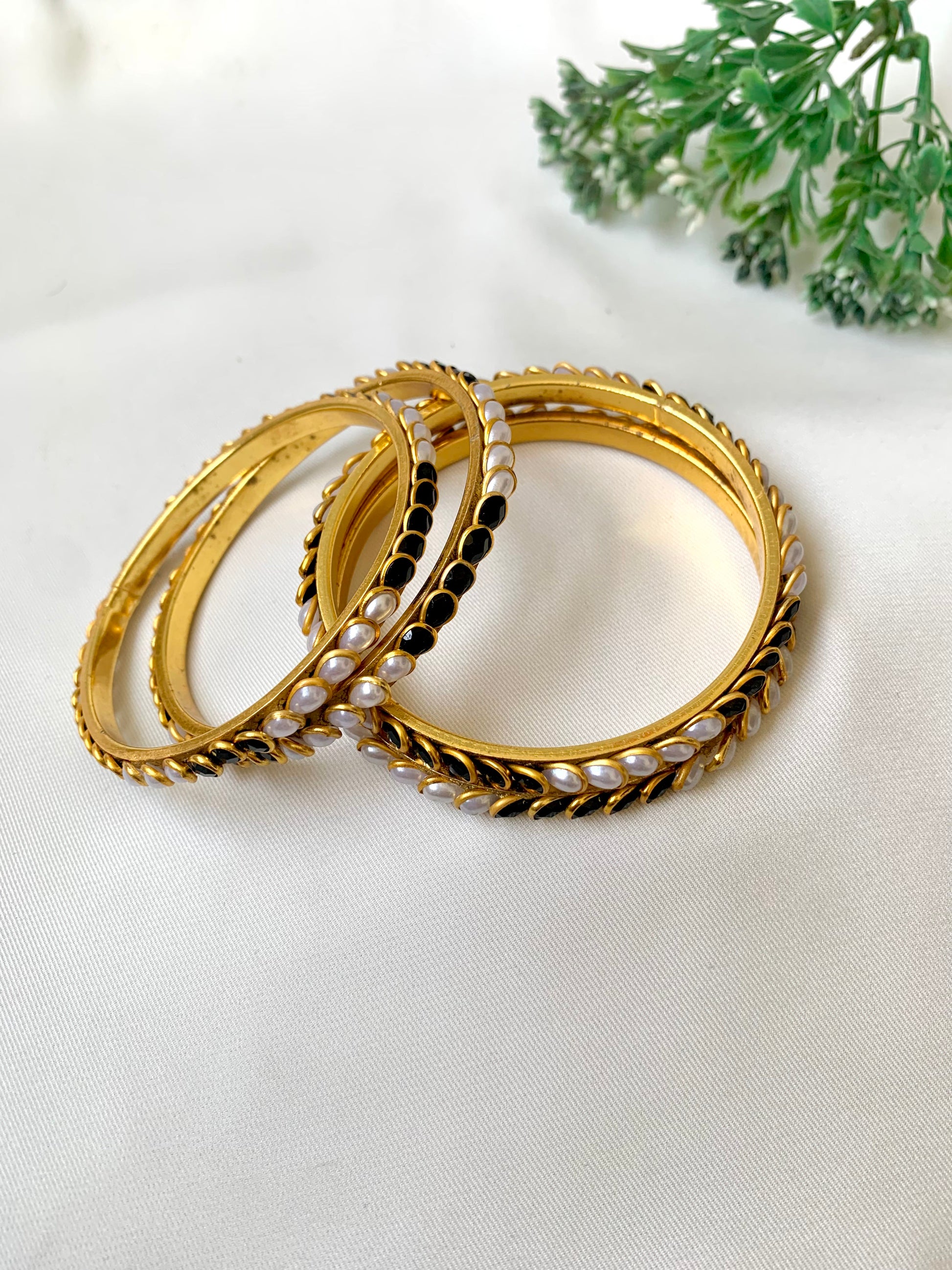 Handcrafted Inaya Bangles in 22kt gold plating with Onyx and Pearls — set of 4 bangles by Zamal Jewels.