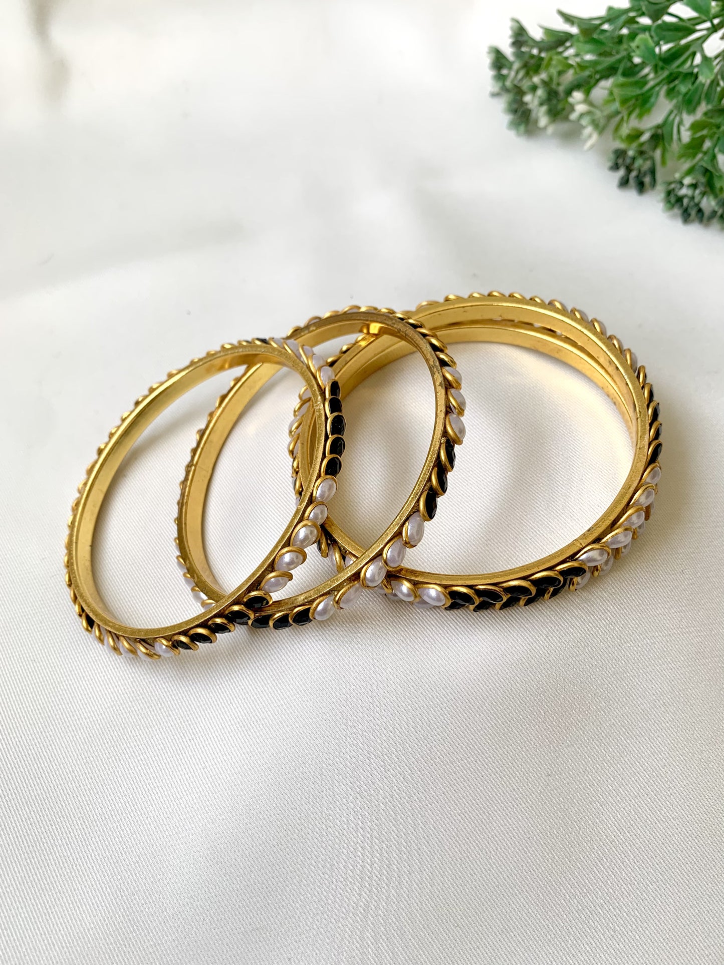 Handcrafted Inaya Bangles in 22kt gold plating with Onyx and Pearls — set of 4 bangles by Zamal Jewels.