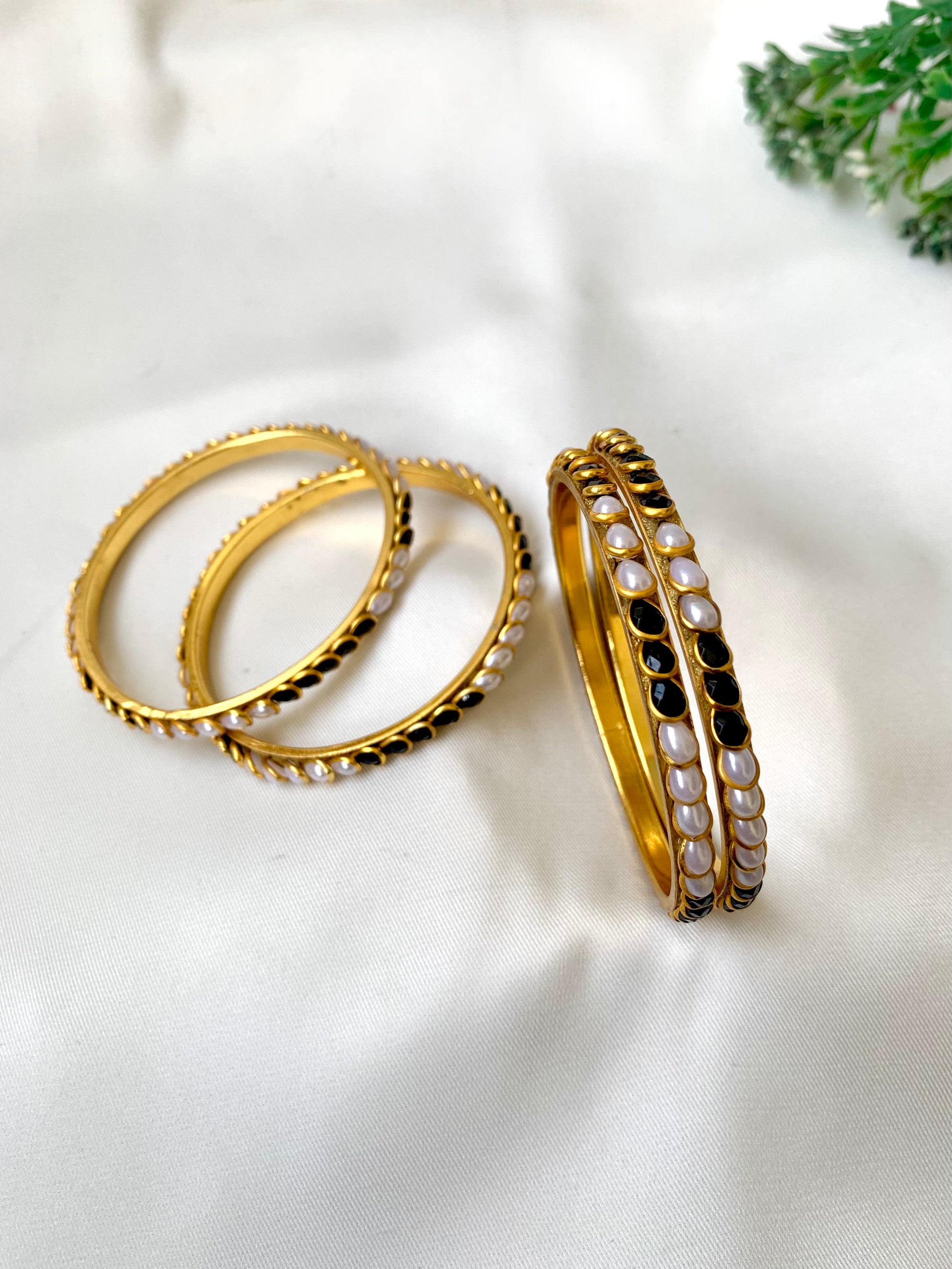 Handcrafted Inaya Bangles in 22kt gold plating with Onyx and Pearls — set of 4 bangles by Zamal Jewels.
