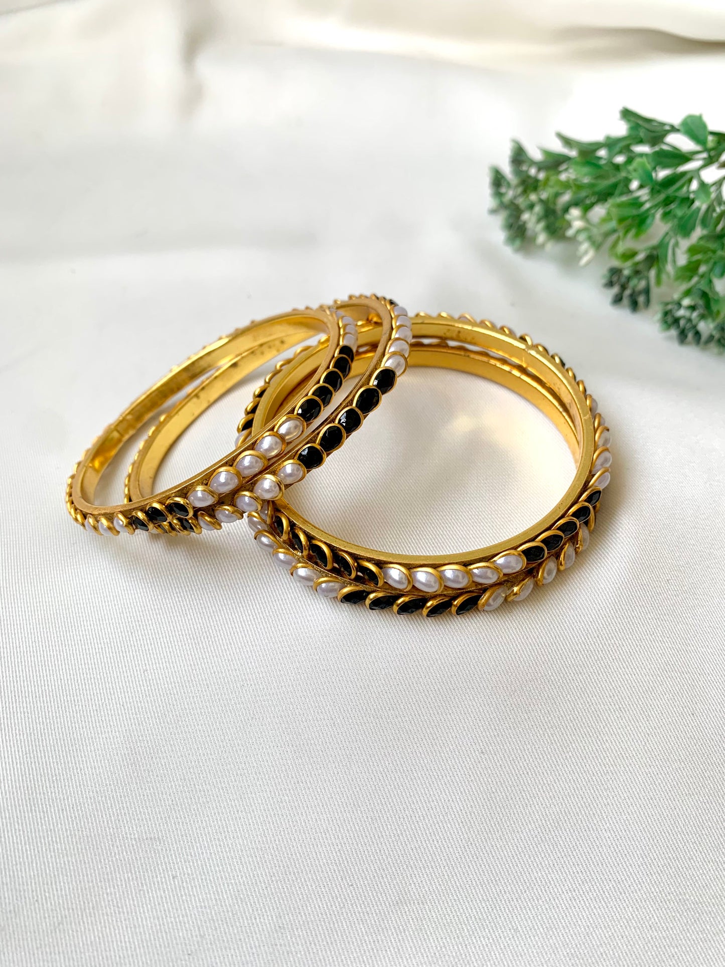 Handcrafted Inaya Bangles in 22kt gold plating with Onyx and Pearls — set of 4 bangles by Zamal Jewels.