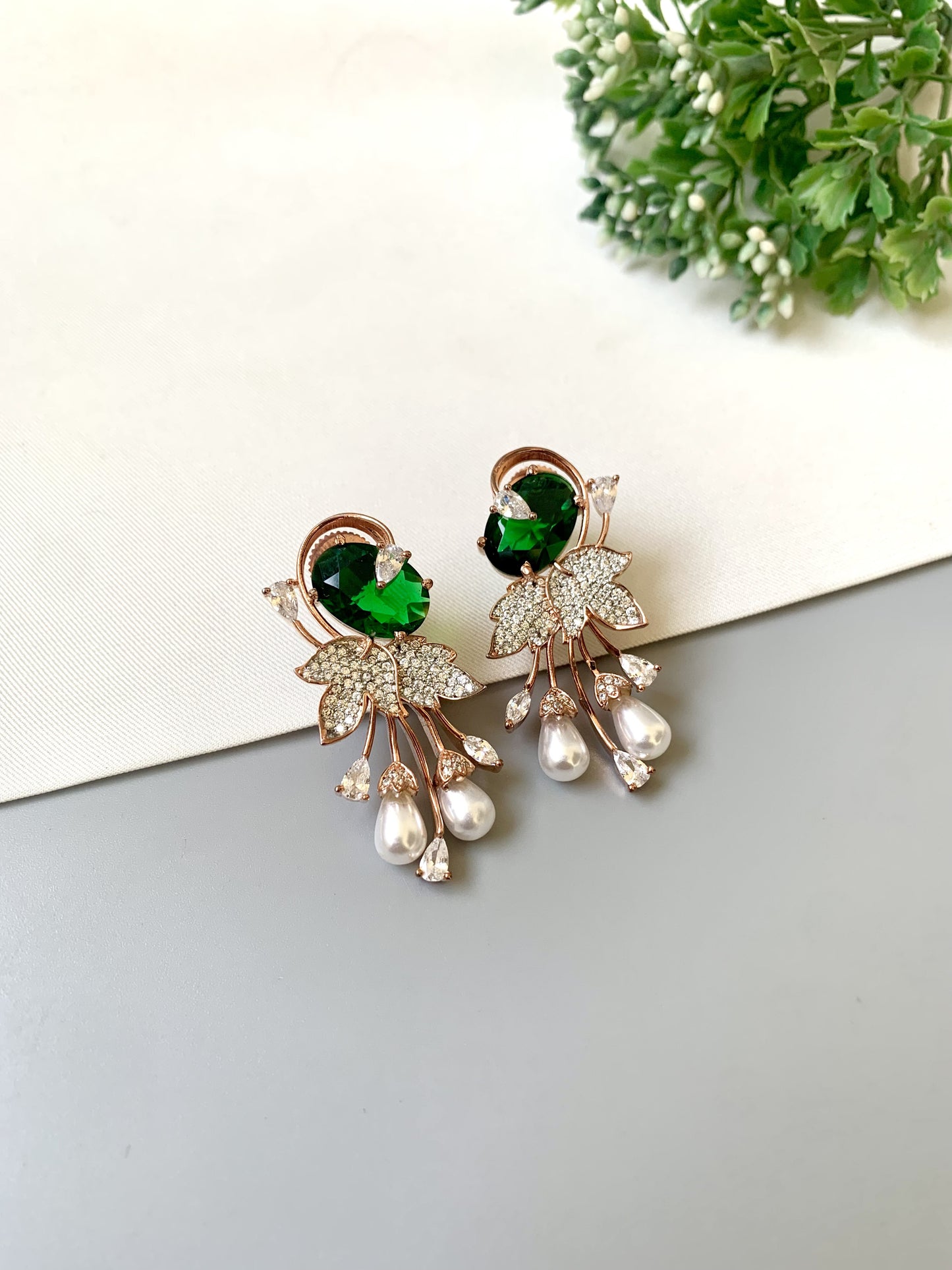 Handcrafted rose gold plated emerald drop earrings with American diamonds, onyx and pearls by Zamal Jewels