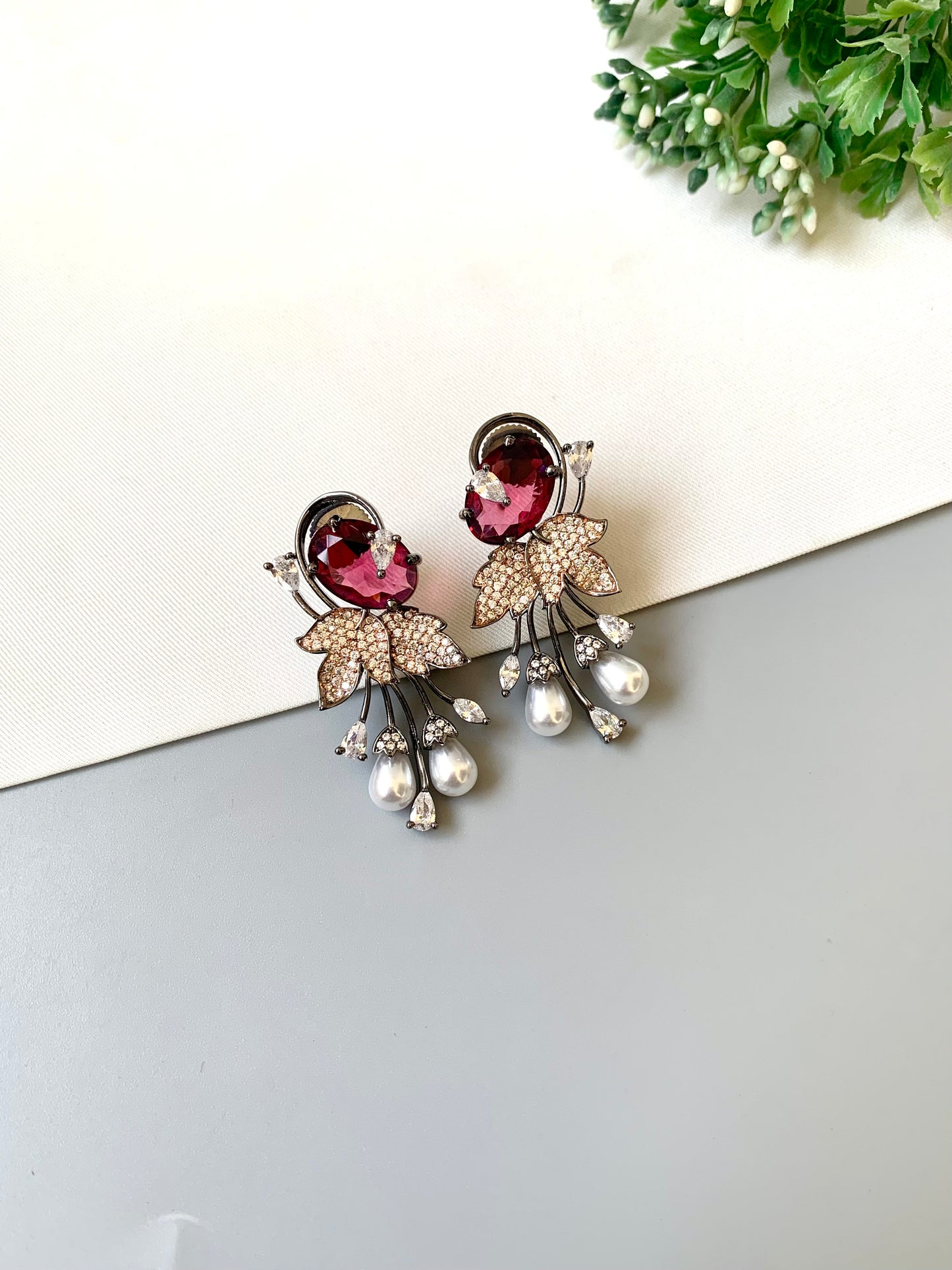 Handcrafted rose gold plated ruby drop earrings with American diamonds and pearls by Zamal Jewels