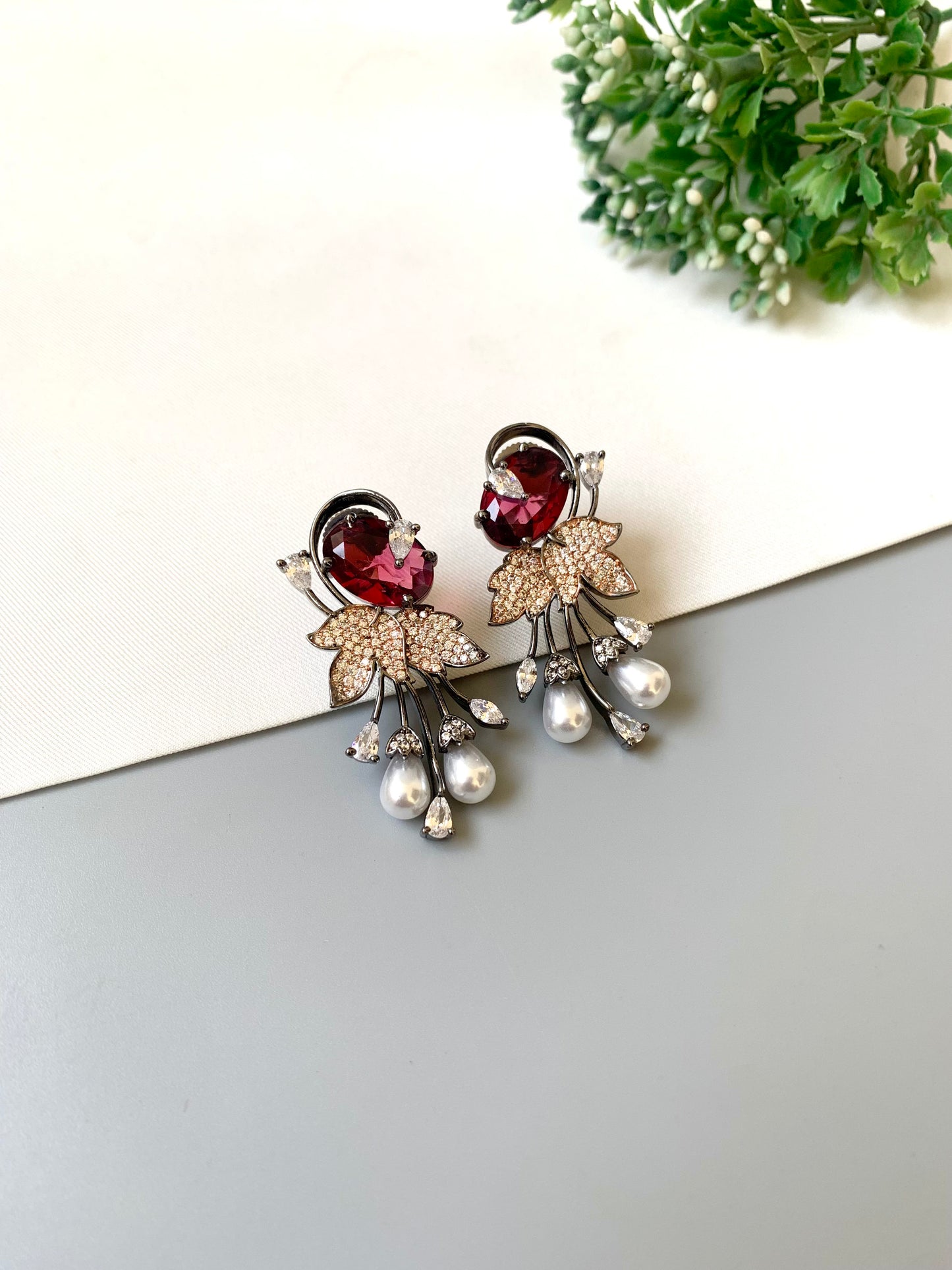 Handcrafted rose gold plated ruby drop earrings with American diamonds and pearls by Zamal Jewels