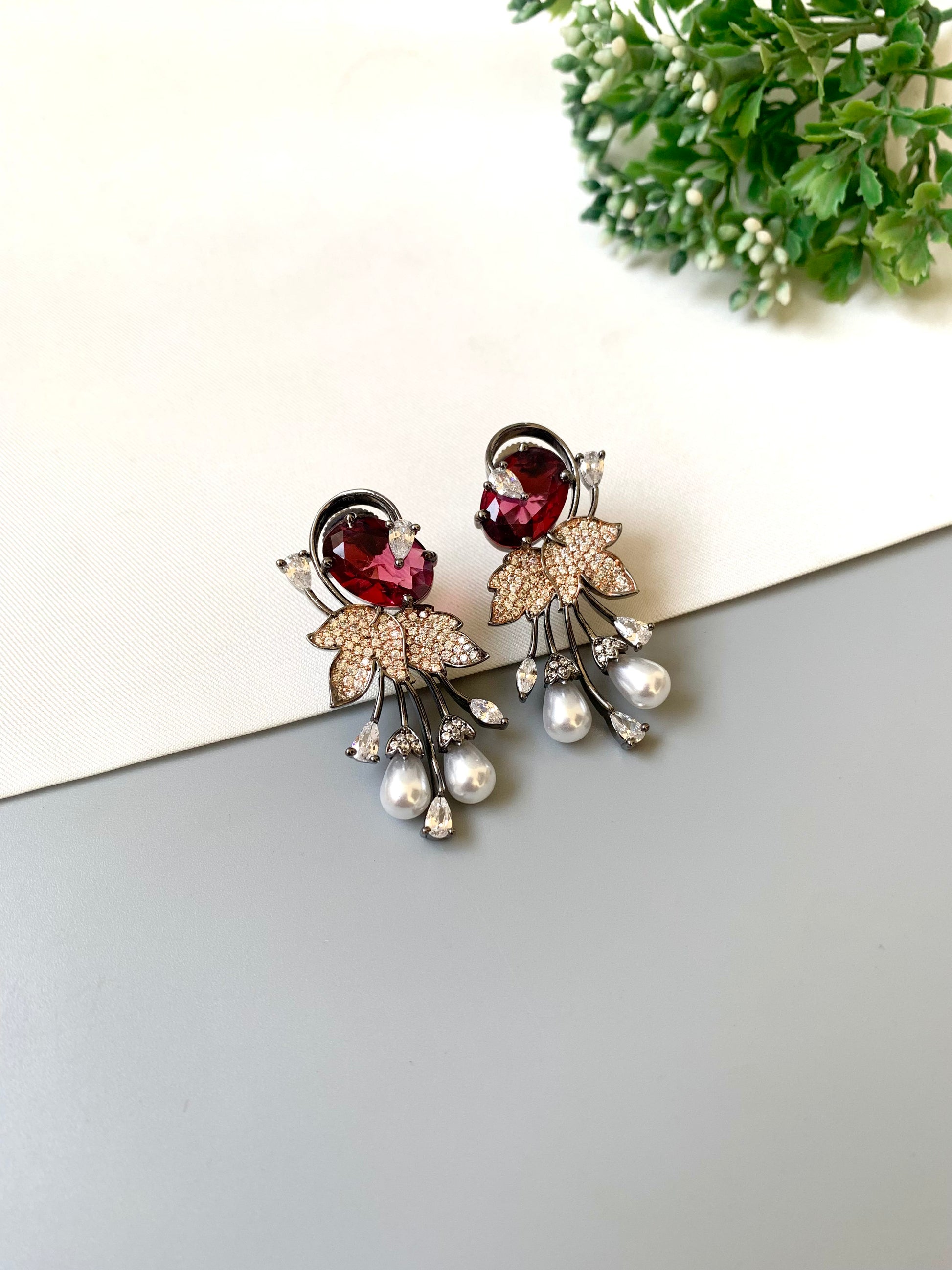 Handcrafted rose gold plated ruby drop earrings with American diamonds and pearls by Zamal Jewels