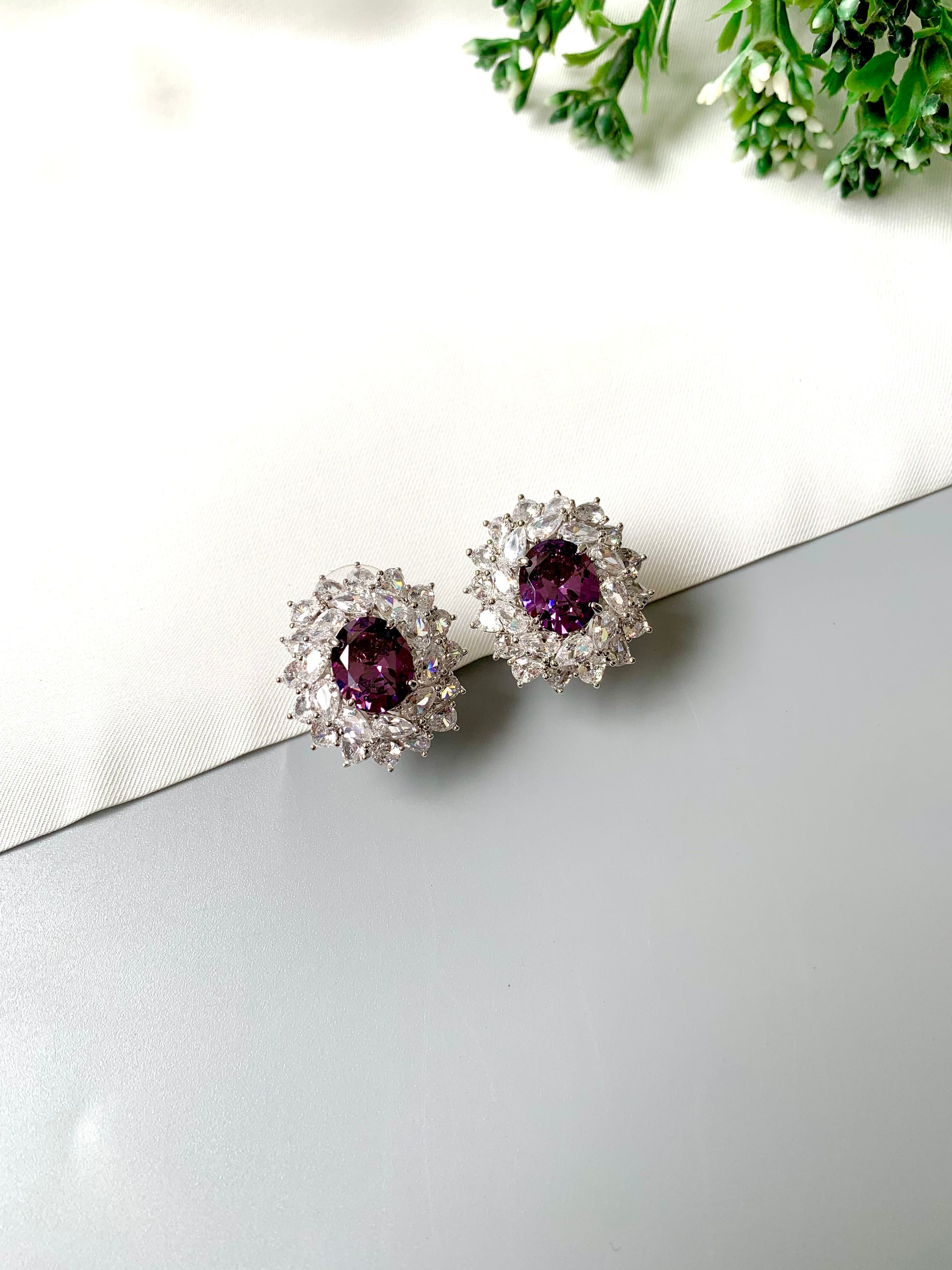 Hand crafted rhodium plated studs in platinum finish featuring semi-precious amethyst and American Diamonds by Zamal Jewels