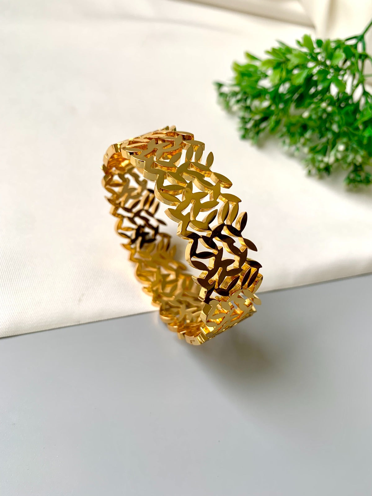 Gold-plated openable bracelet with leaf cut-out design, made from 316L stainless steel – waterproof & tarnish-proof by Zamal Jewels.