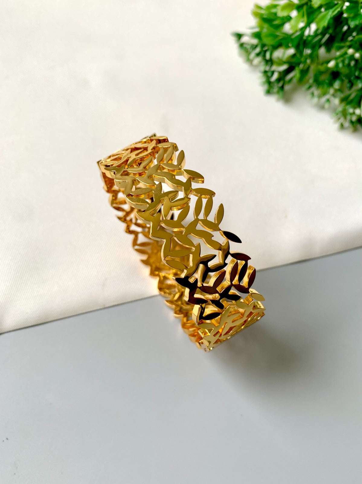 Gold-plated openable bracelet with leaf cut-out design, made from 316L stainless steel – waterproof & tarnish-proof by Zamal Jewels.