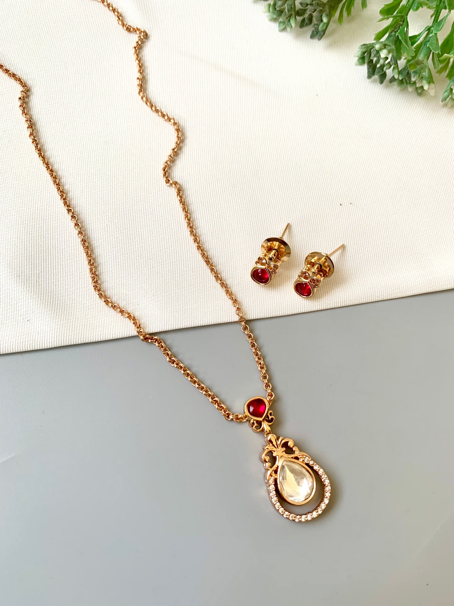 Handcrafted Lyana Pendant Set in 22kt Victorian rose gold plating with Semi-Precious Ruby and American Diamonds — includes chain, pendant, and studs by Zamal Jewels.