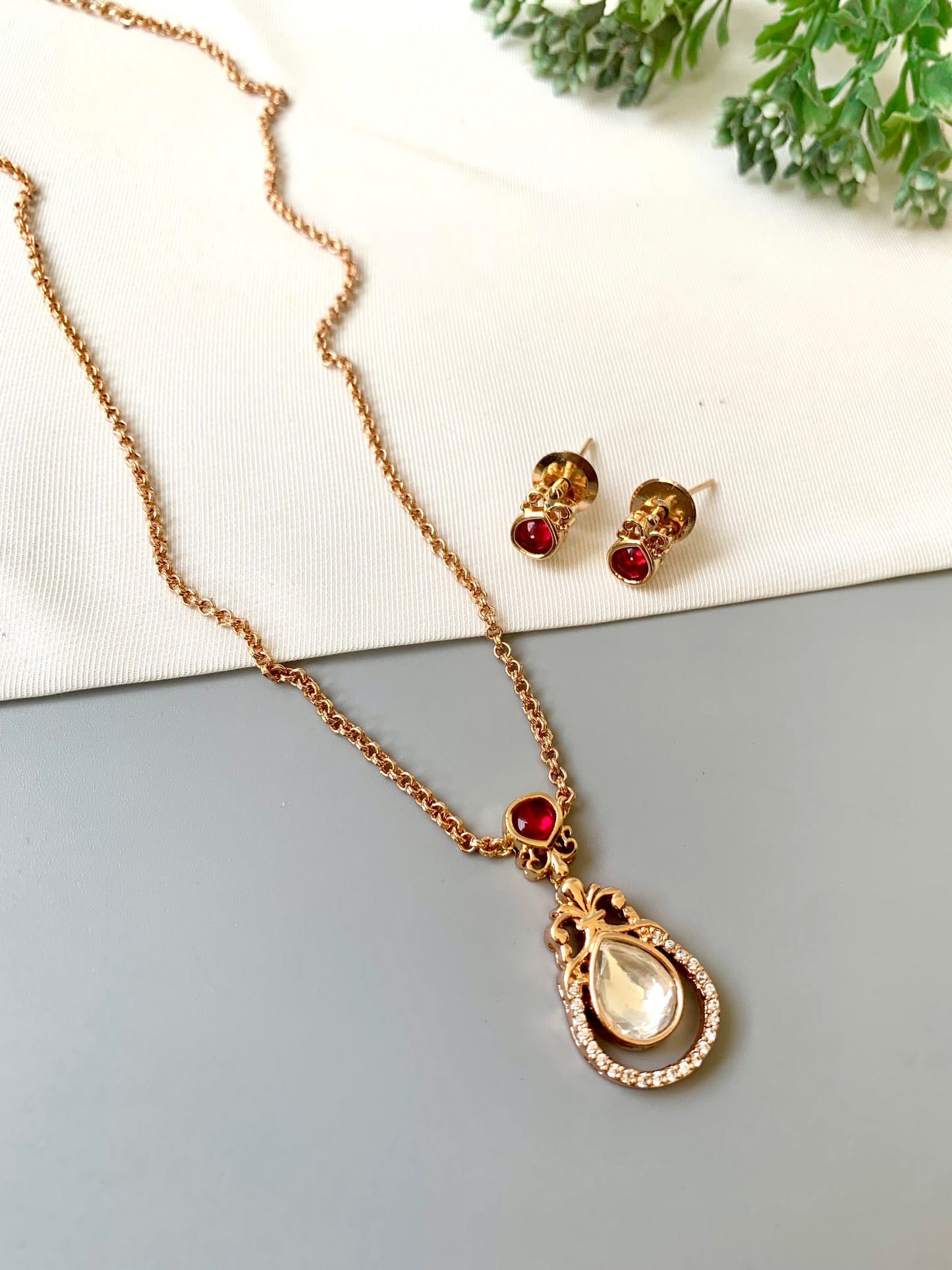 Handcrafted Lyana Pendant Set in 22kt Victorian rose gold plating with Semi-Precious Ruby and American Diamonds — includes chain, pendant, and studs by Zamal Jewels.