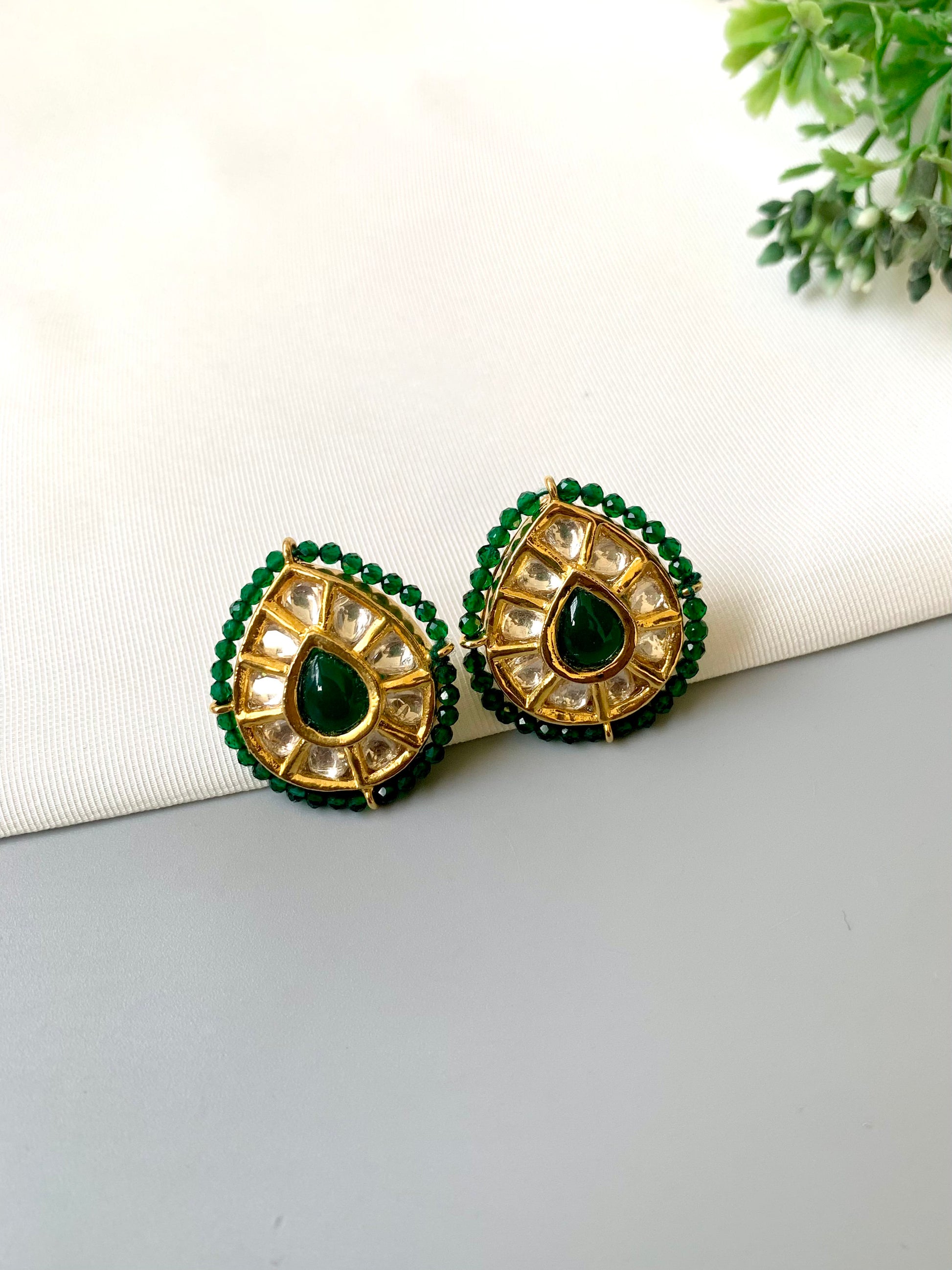 Handcrafted Mehreen Emerald Studs in 22kt gold plating with Polki Kundan, hand-painted Meena work, semi-precious Emerald stones, and pearls by Zamal Jewels.
