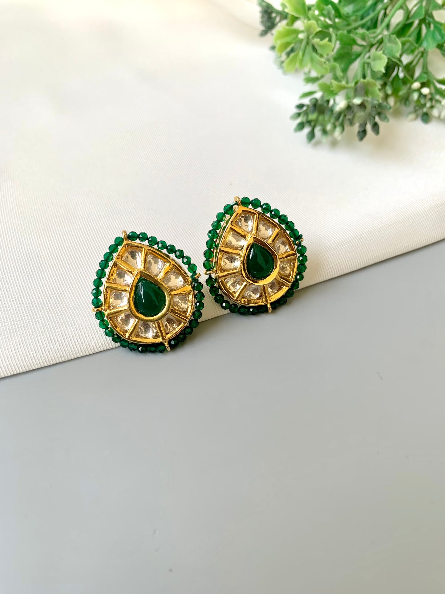 Handcrafted Mehreen Emerald Studs in 22kt gold plating with Polki Kundan, hand-painted Meena work, semi-precious Emerald stones, and pearls by Zamal Jewels.