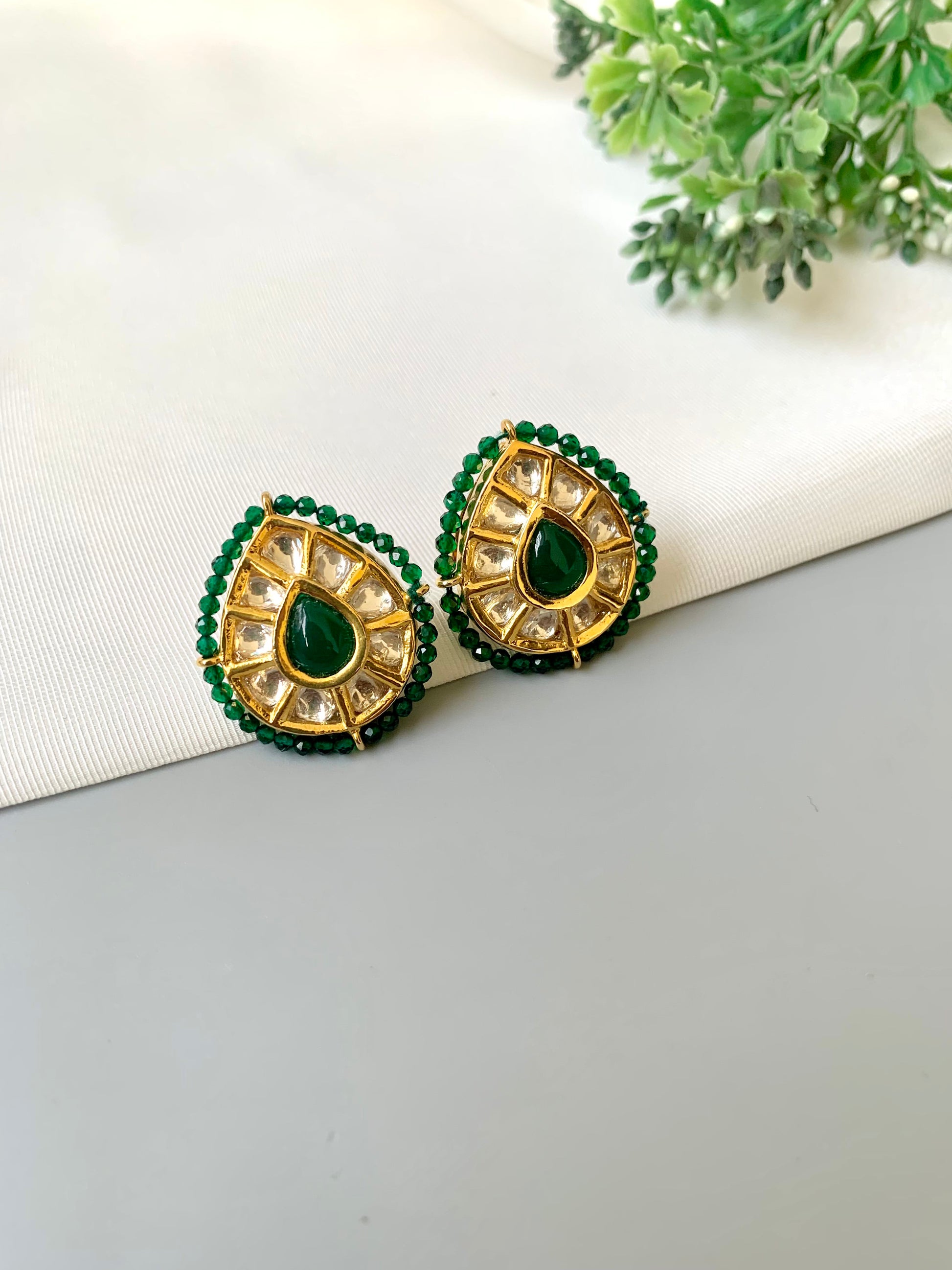 Handcrafted Mehreen Emerald Studs in 22kt gold plating with Polki Kundan, hand-painted Meena work, semi-precious Emerald stones, and pearls by Zamal Jewels.
