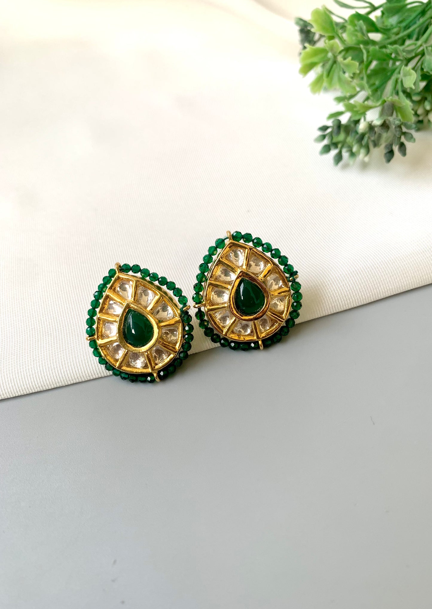 Handcrafted Mehreen Emerald Studs in 22kt gold plating with Polki Kundan, hand-painted Meena work, semi-precious Emerald stones, and pearls by Zamal Jewels.