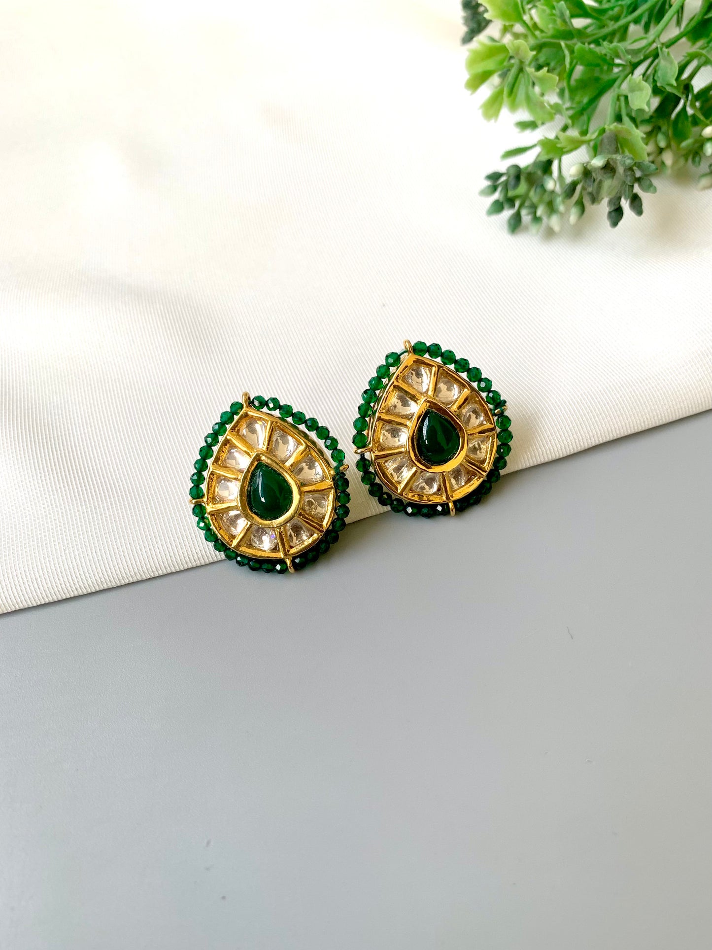 Handcrafted Mehreen Emerald Studs in 22kt gold plating with Polki Kundan, hand-painted Meena work, semi-precious Emerald stones, and pearls by Zamal Jewels.