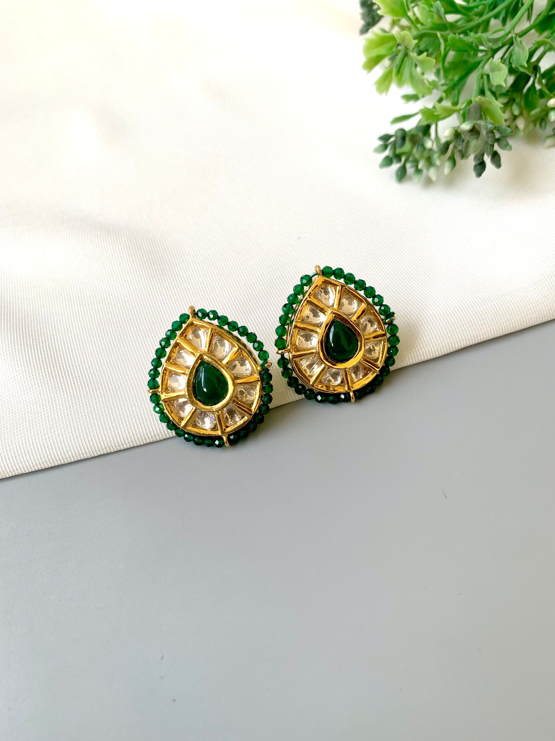 Handcrafted Mehreen Emerald Studs in 22kt gold plating with Polki Kundan, hand-painted Meena work, semi-precious Emerald stones, and pearls by Zamal Jewels.