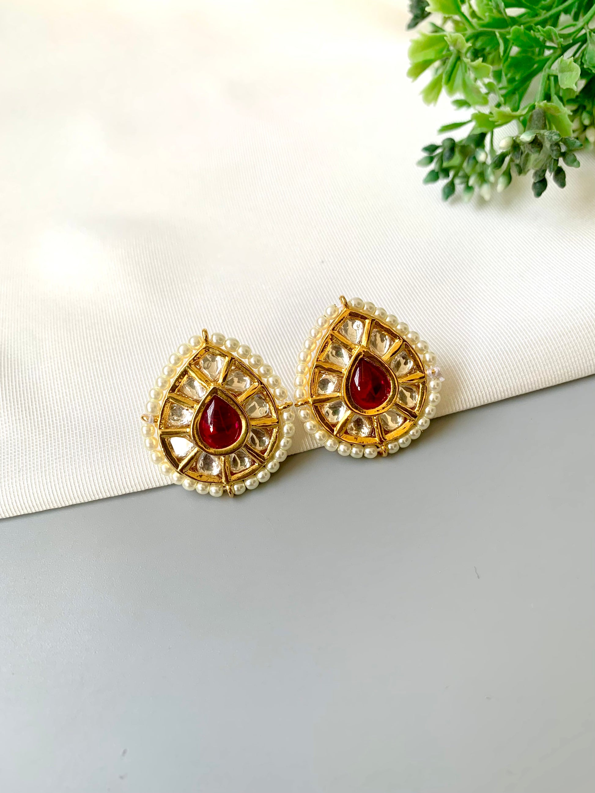Handcrafted Mehreen Ruby Studs in 22kt gold plating with Polki Kundan, pearls, and hand-painted Meena work by Zamal Jewels.